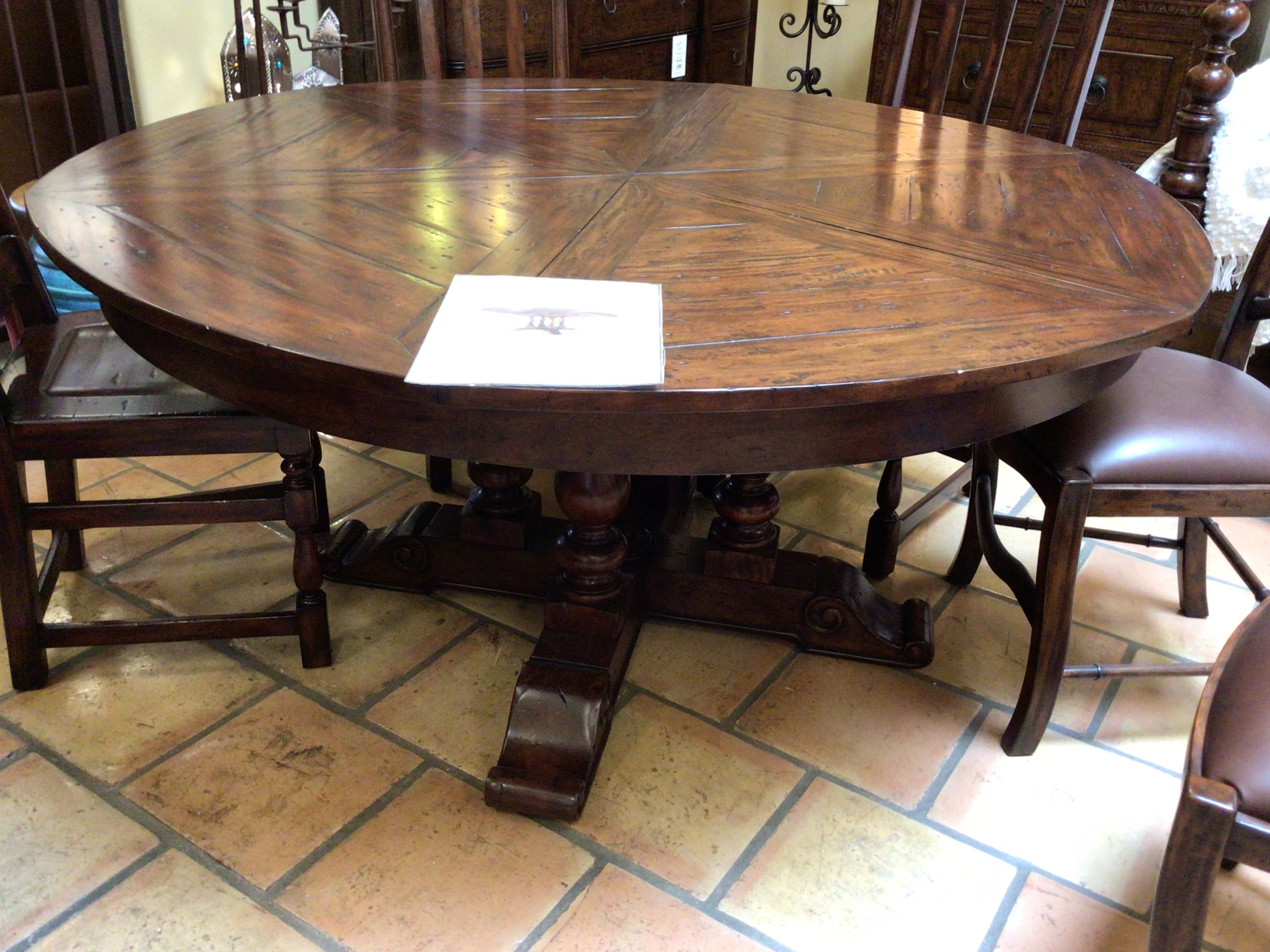 Wooden dining table with chairs on a tiled floor