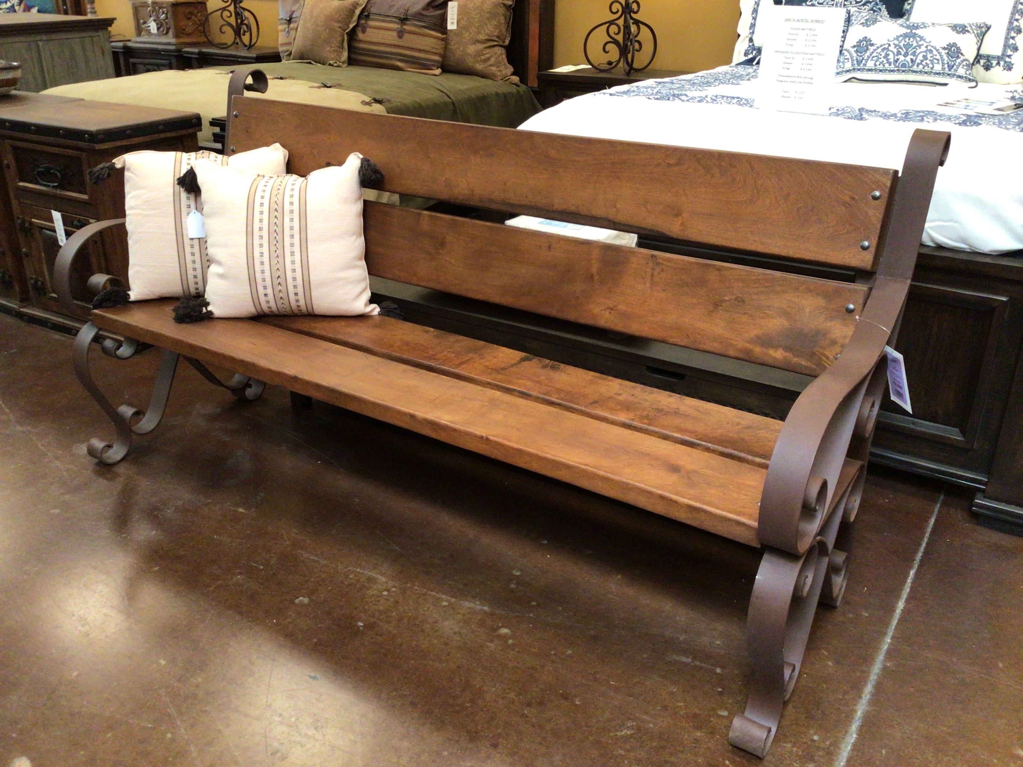 Wooden bench with metal legs in a room setting