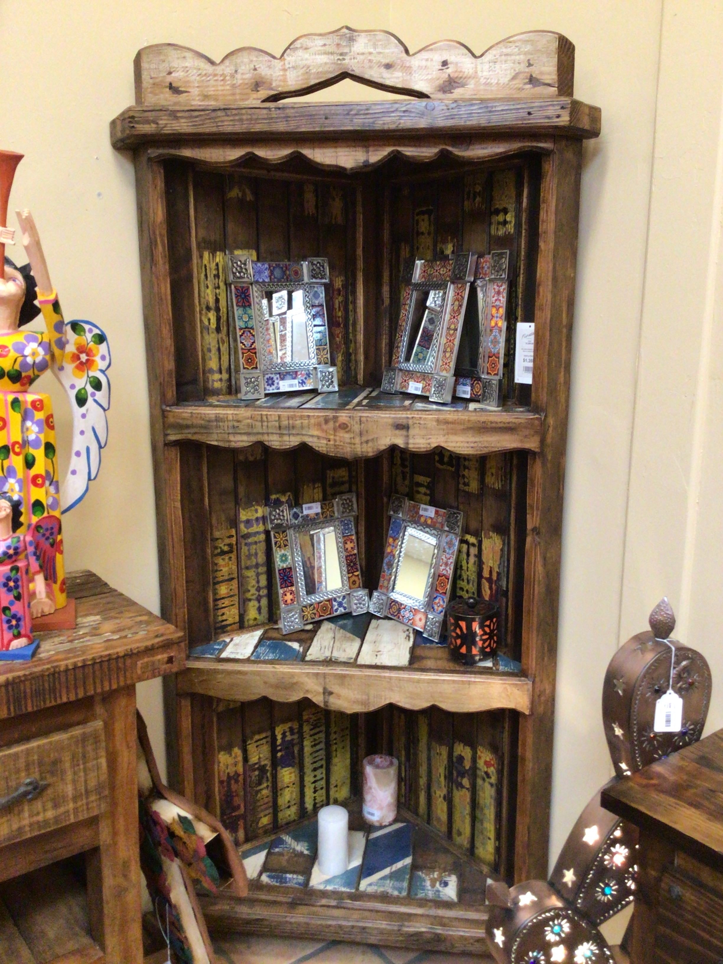 Wooden shelf with decorative items including picture frames and books.