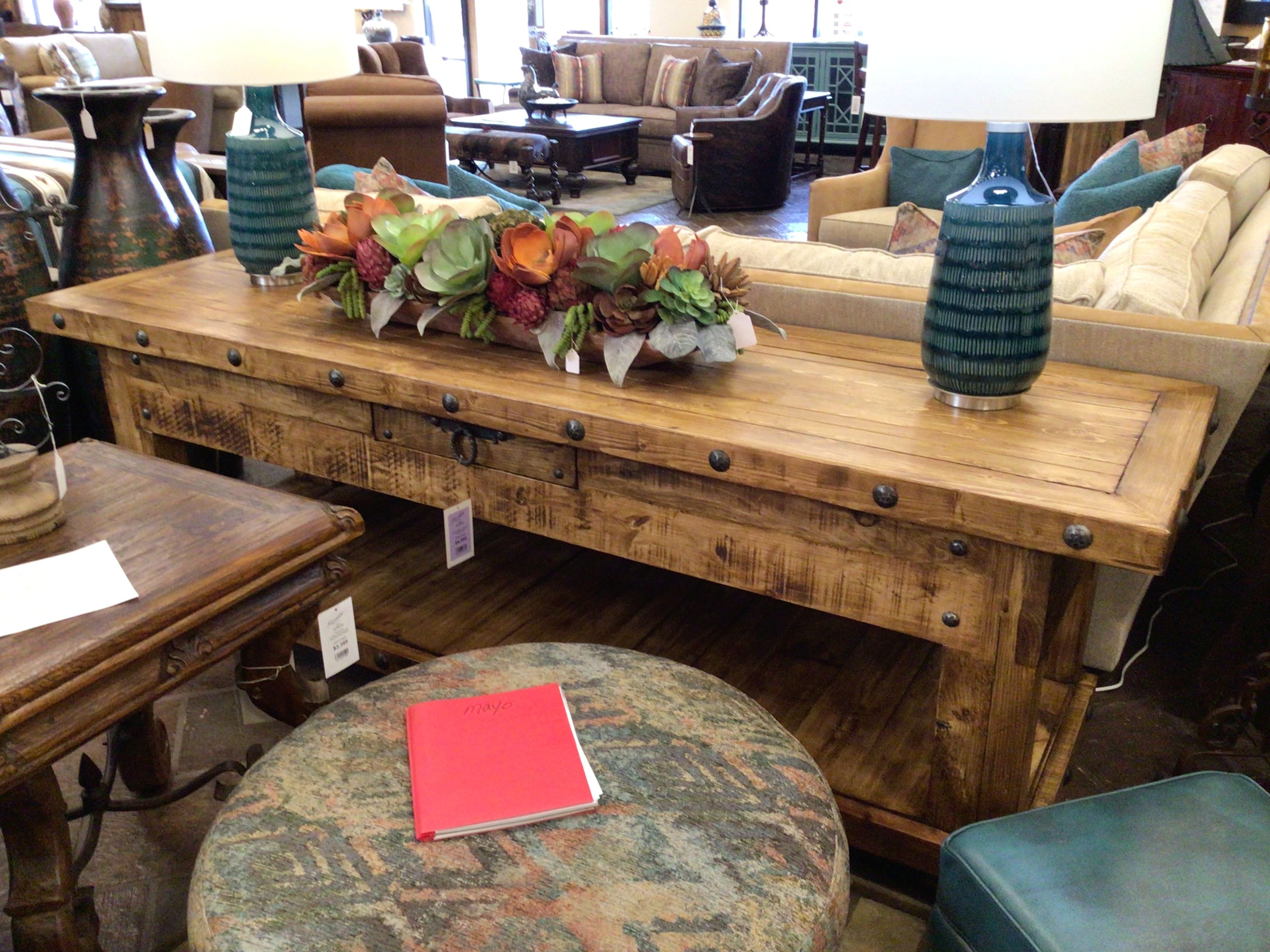 Wooden table with decorative items in a furniture store setting
