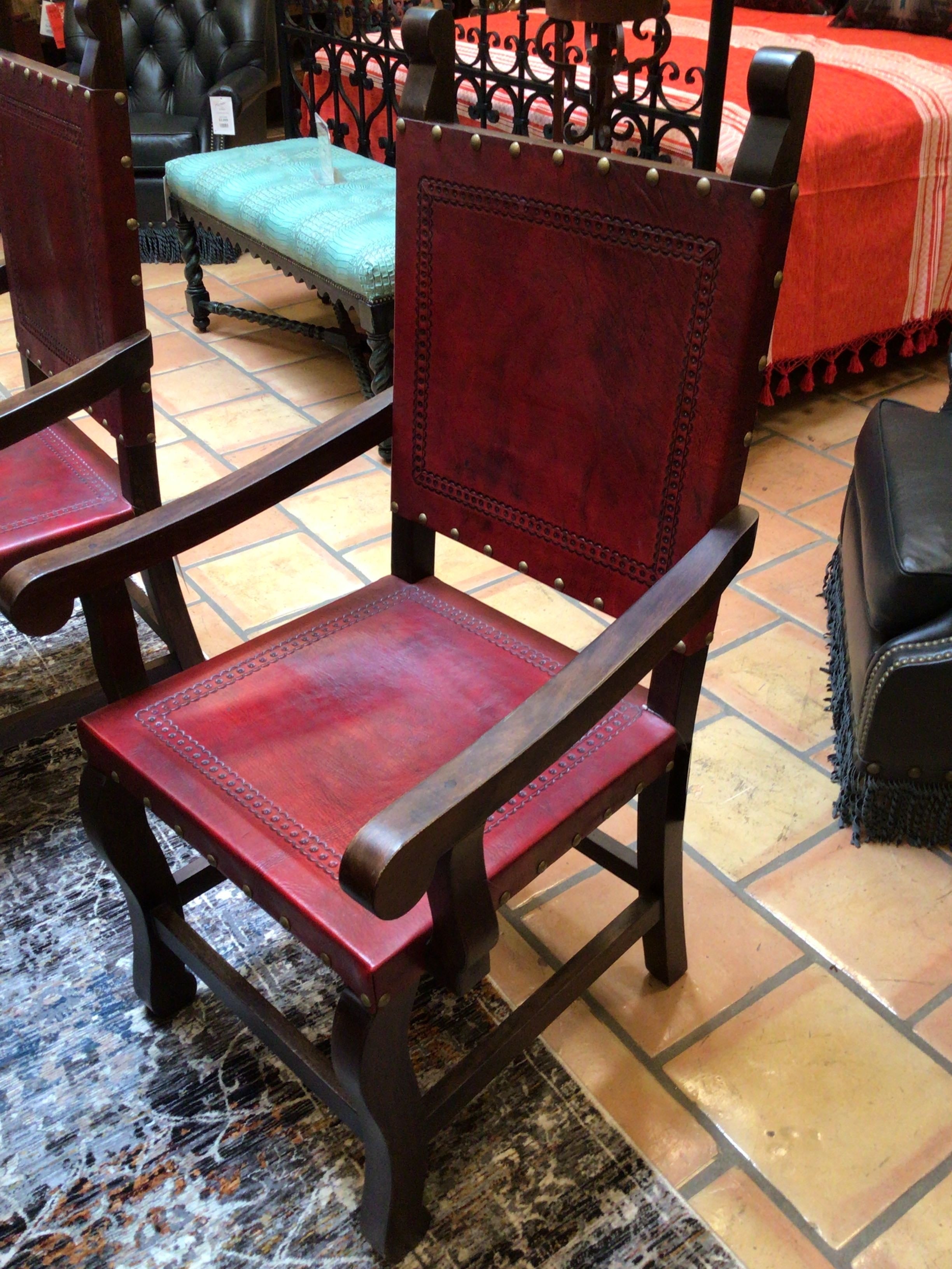 Red leather chair with wooden frame on a tiled floor