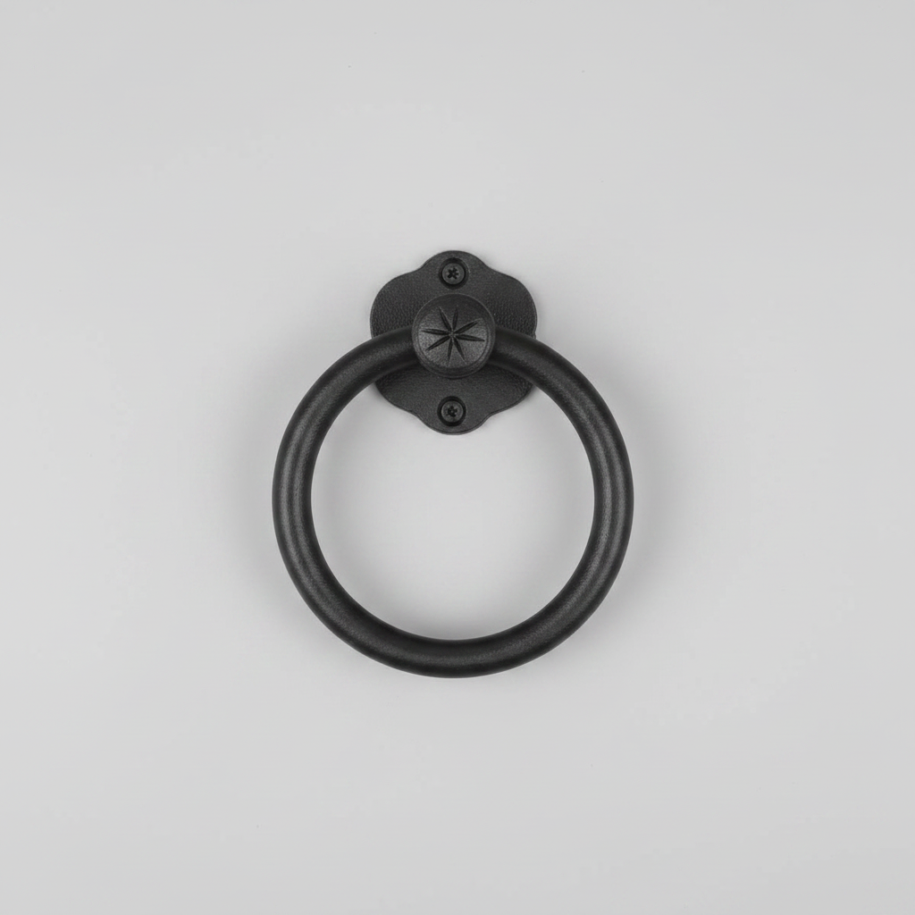 Black metal ring handle on a light gray background