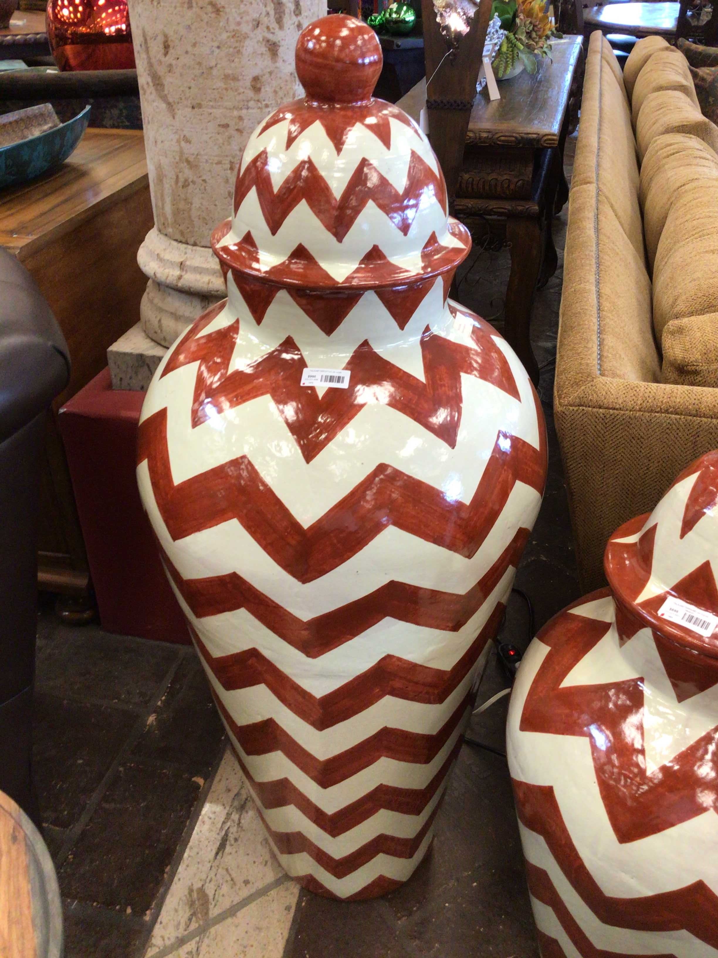 Red and white chevron-patterned vases in a store setting