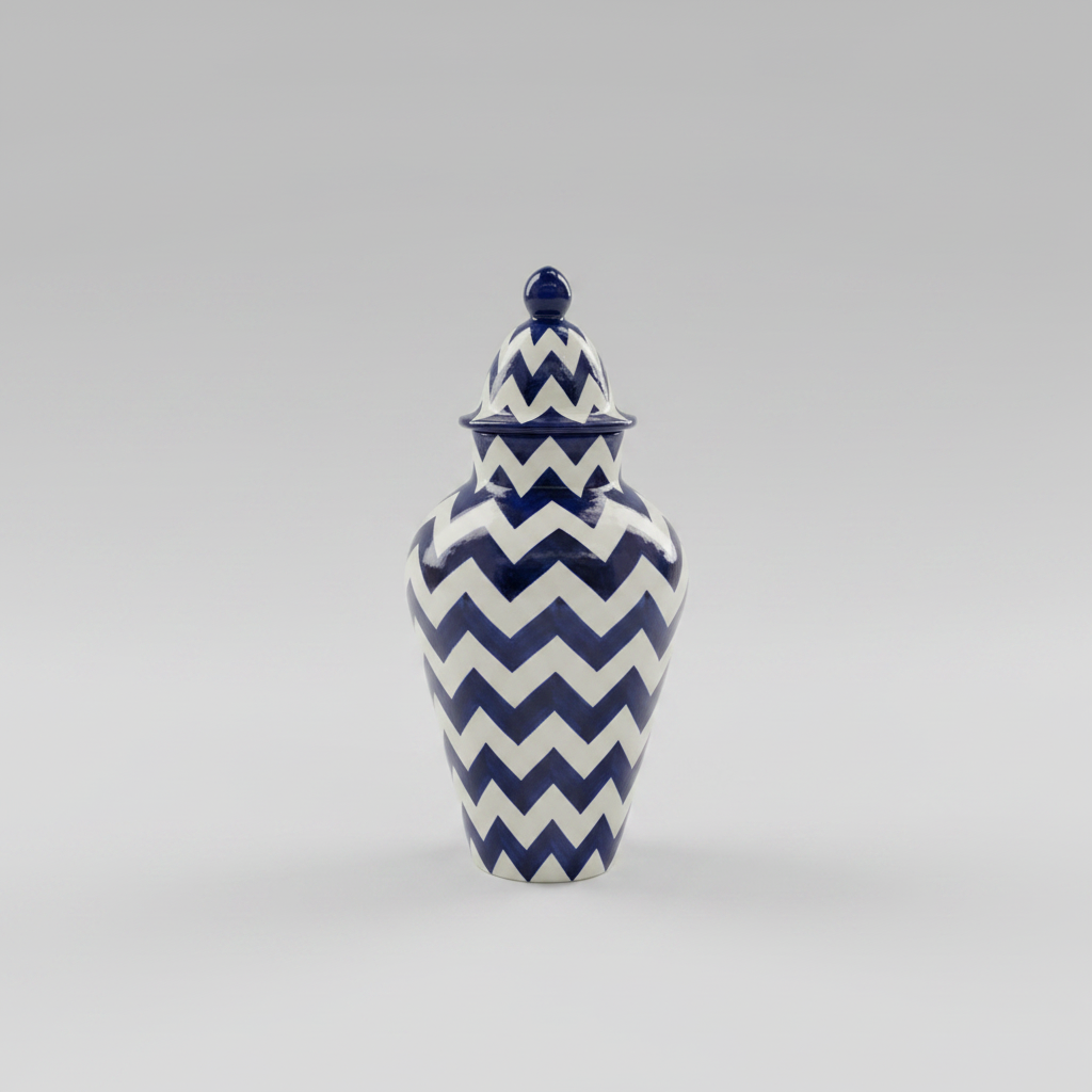 Ceramic jar with blue and white chevron pattern on a gray background