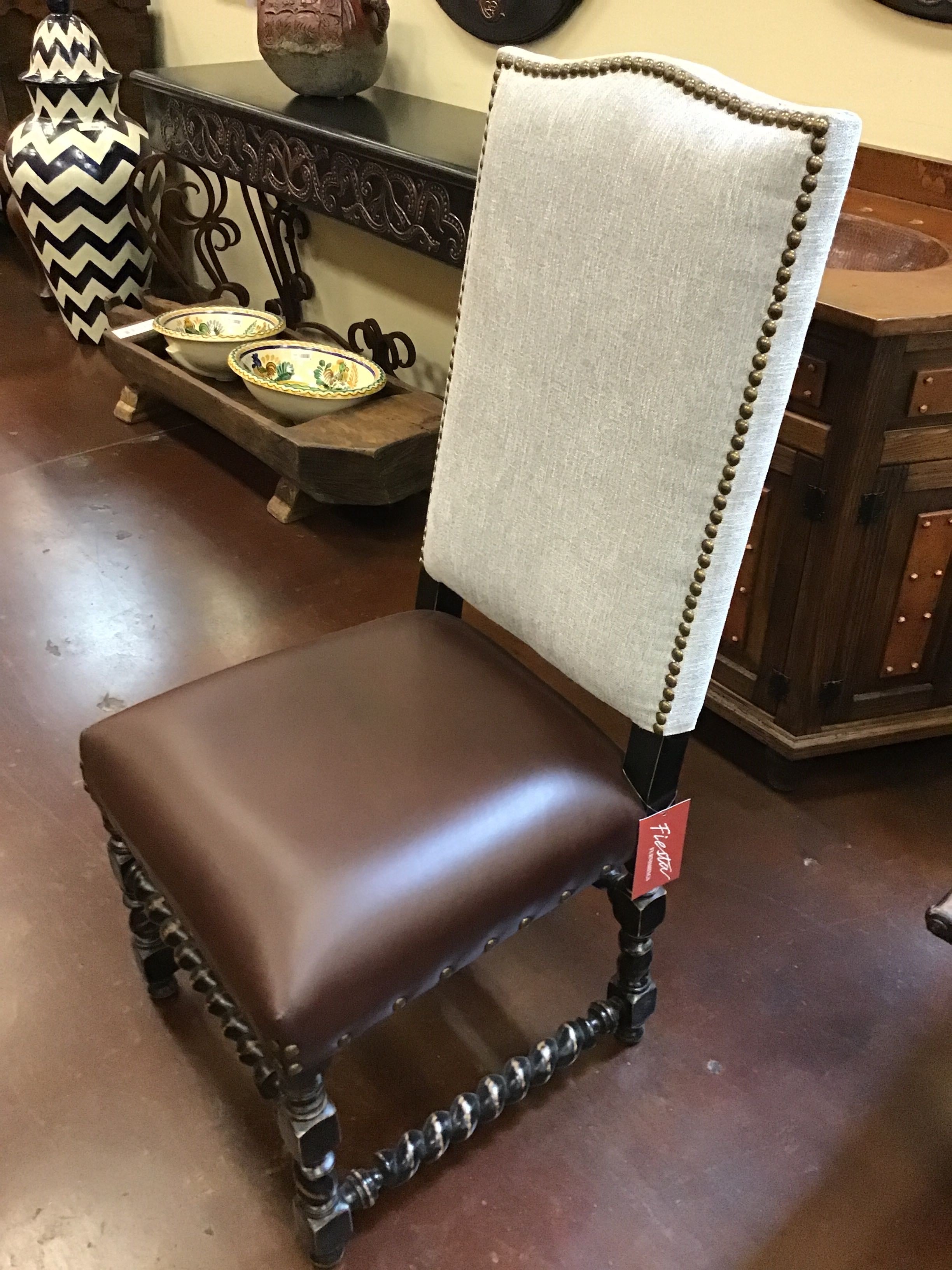 Chair with a brown seat and grey backrest in a room with decorative items.
