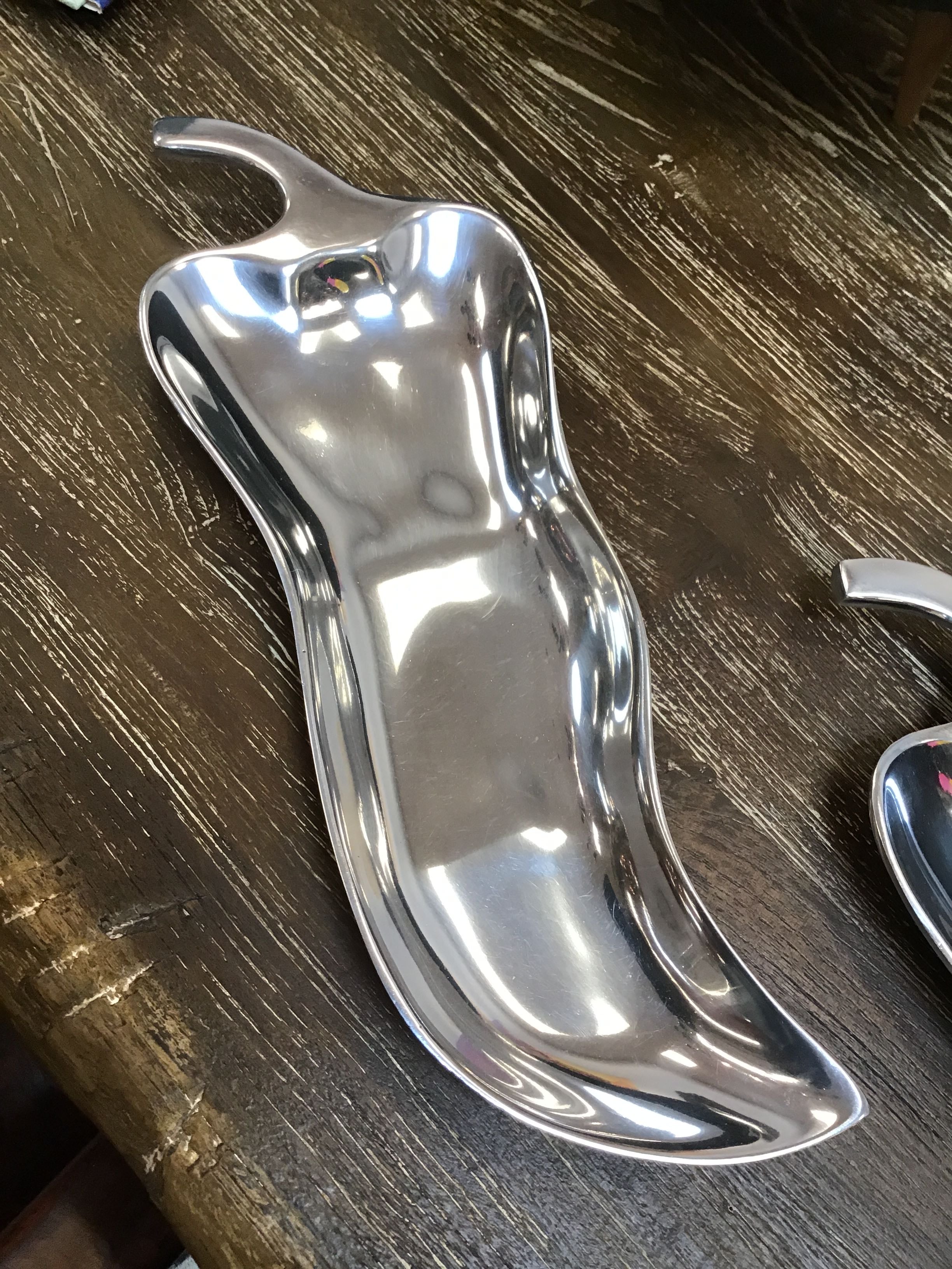Metallic pepper shaker on a wooden surface