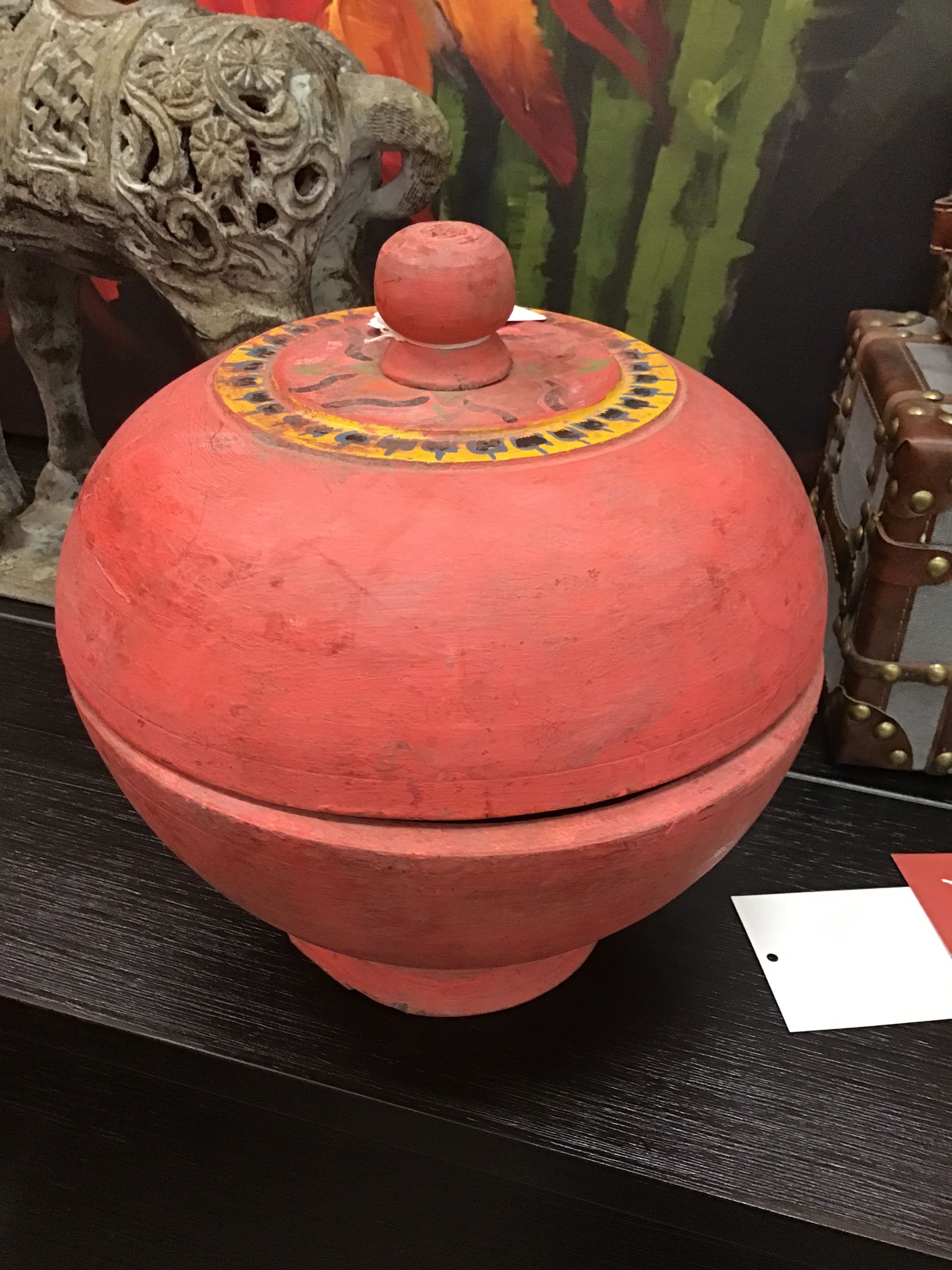 Red wooden box with a lid on a dark surface