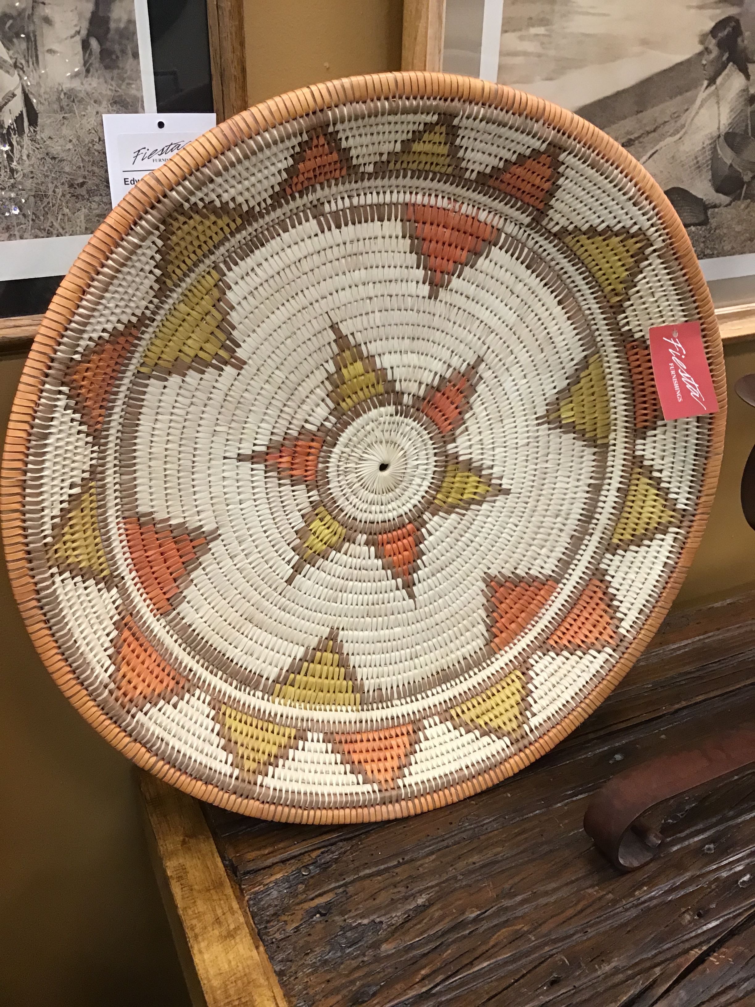 Woven basket with geometric pattern on a wooden surface
