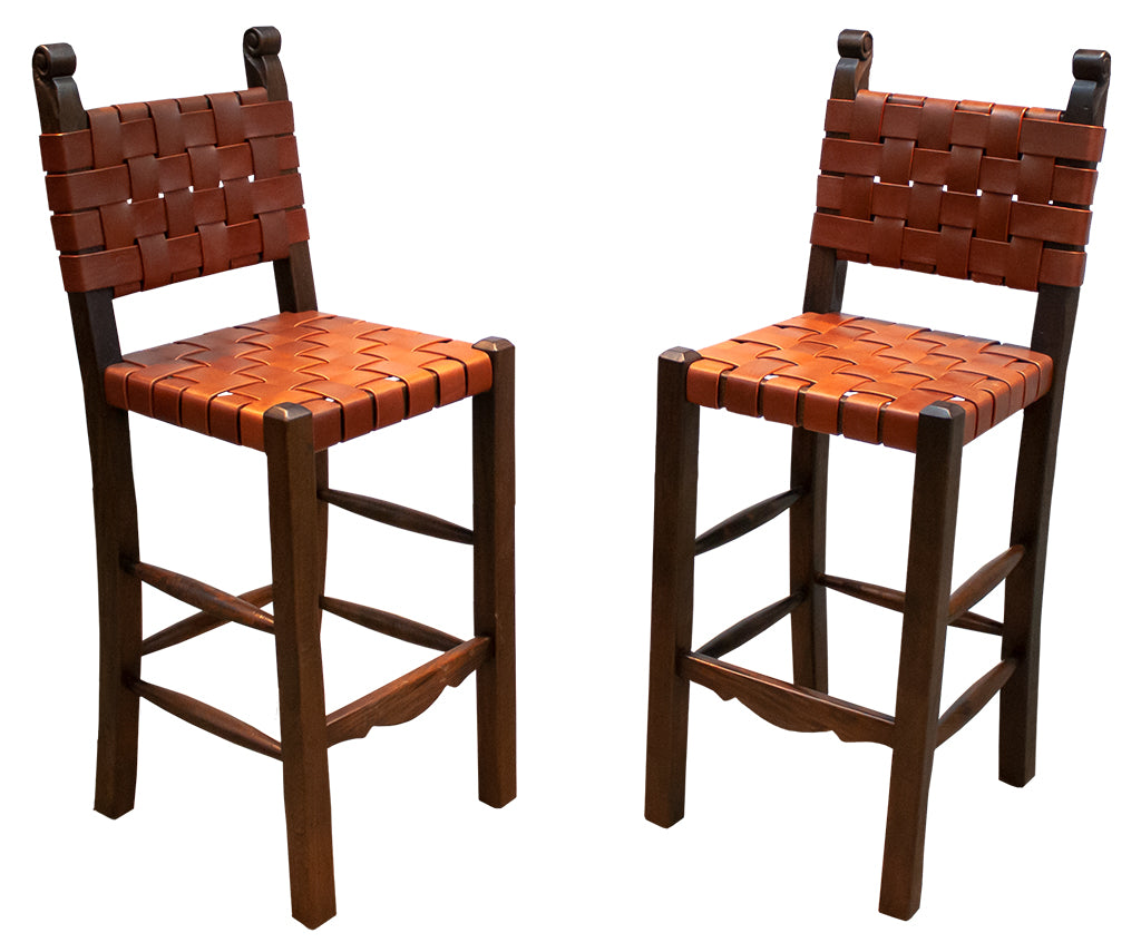 Two wooden bar stools with woven seats on a white background