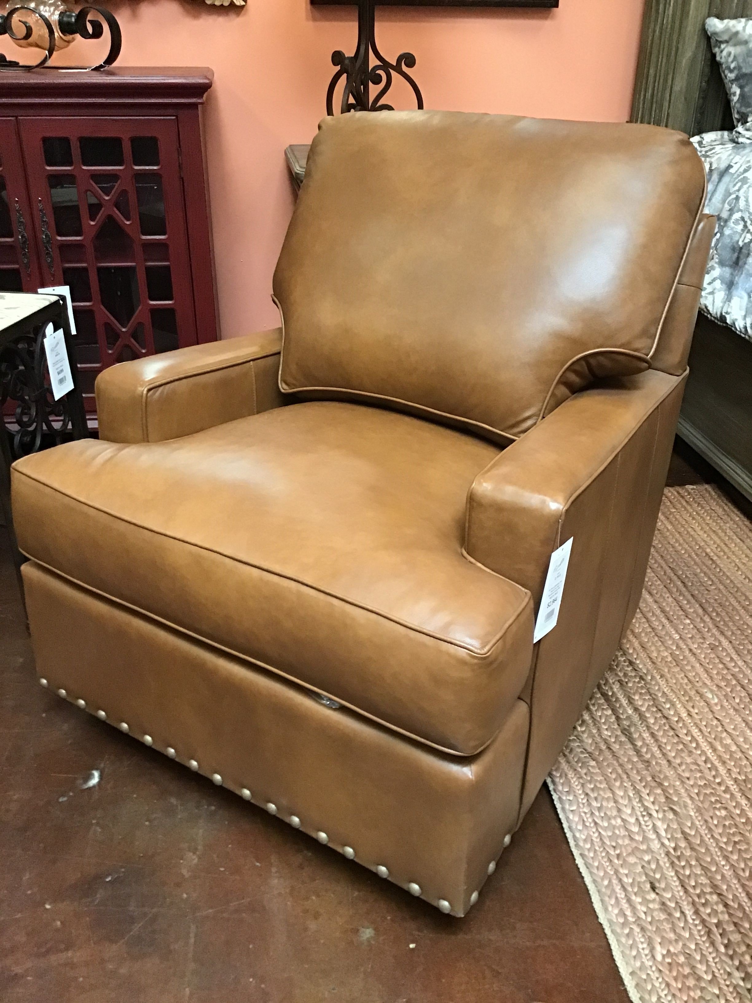 Brown leather armchair with a price tag in a store setting