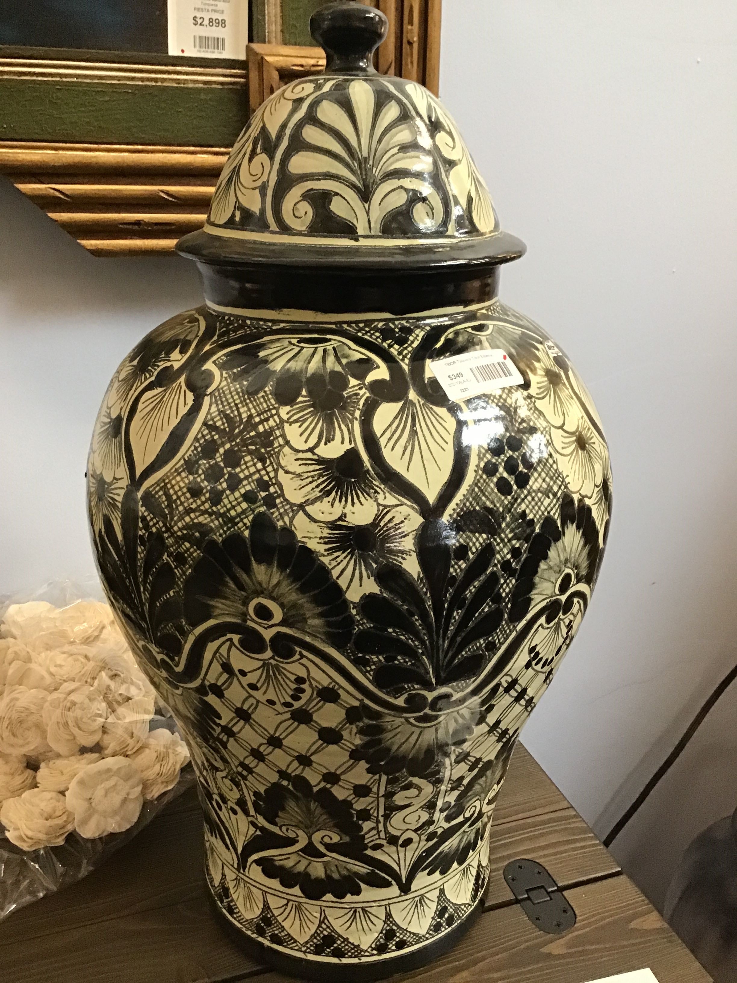 Decorative black and white patterned vase with lid on a table