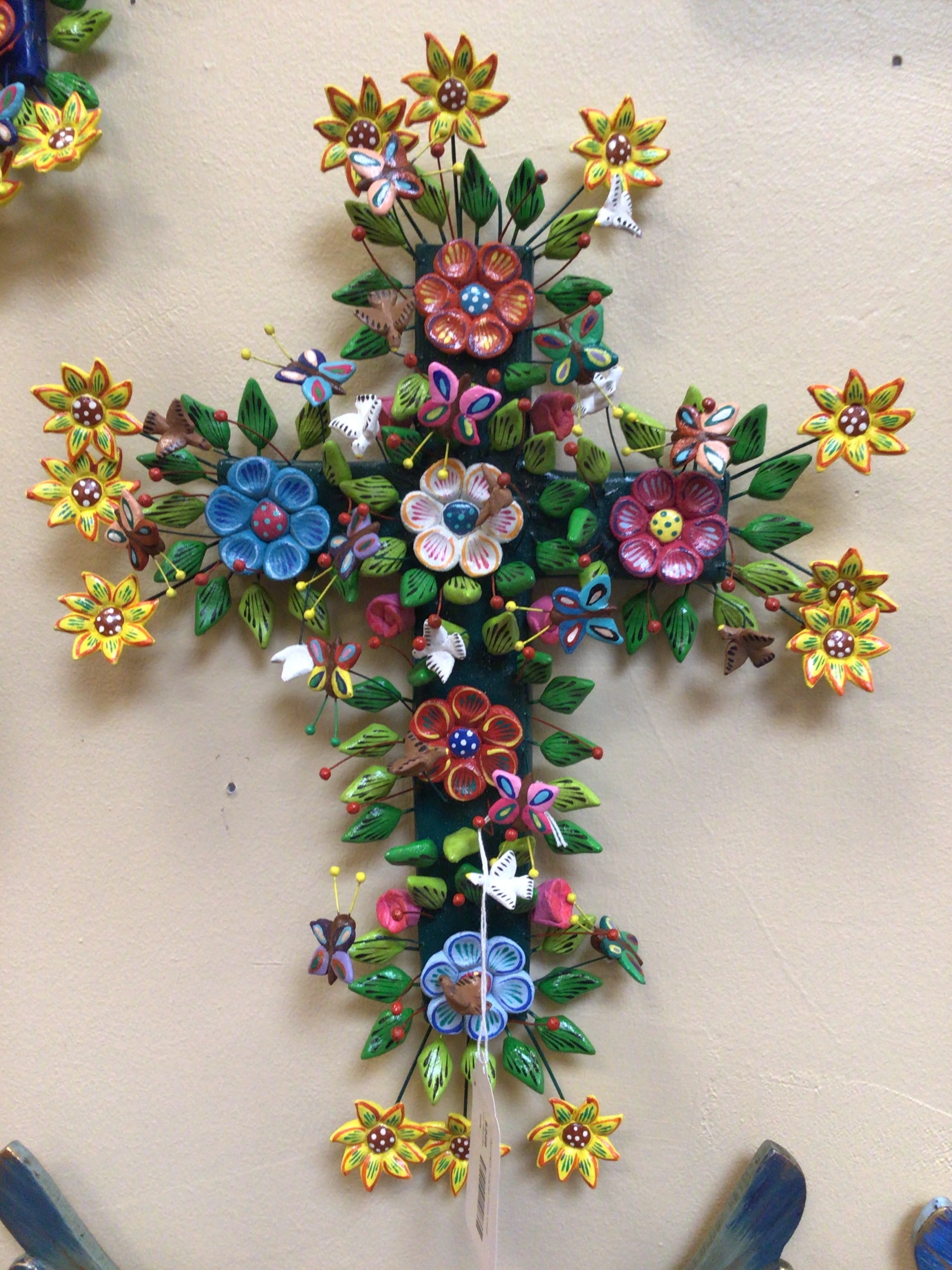 Decorative cross with colorful flowers and butterflies on a beige background