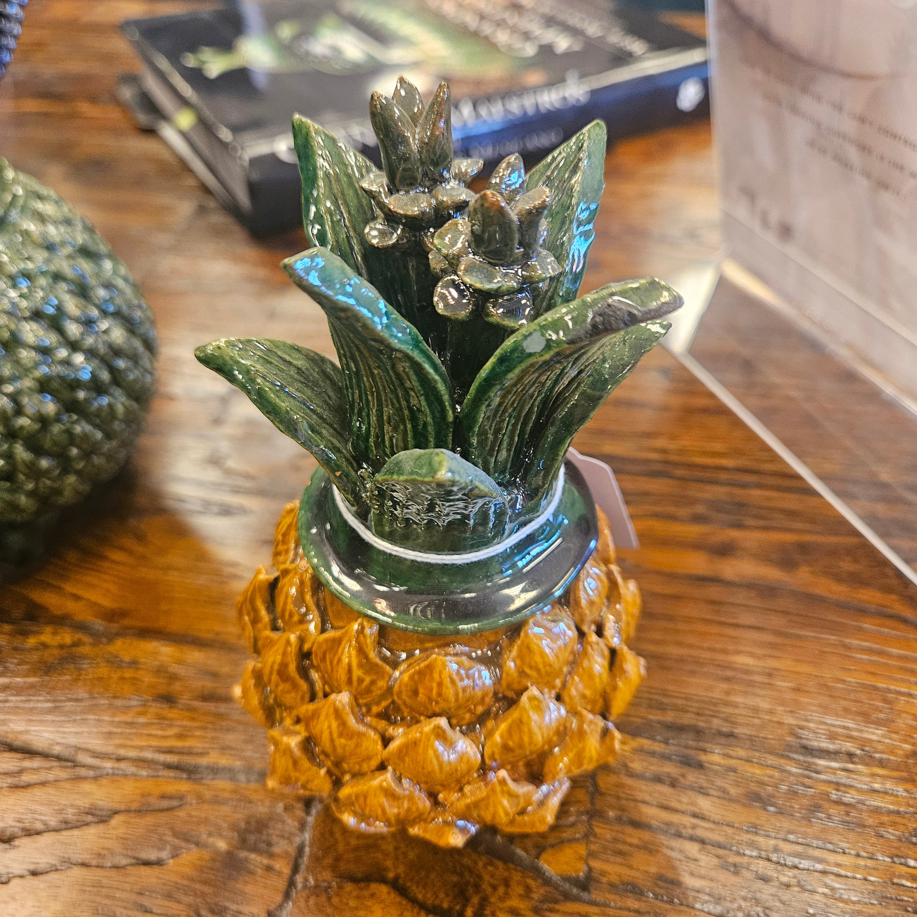 Decorative pineapple figurine on a wooden surface