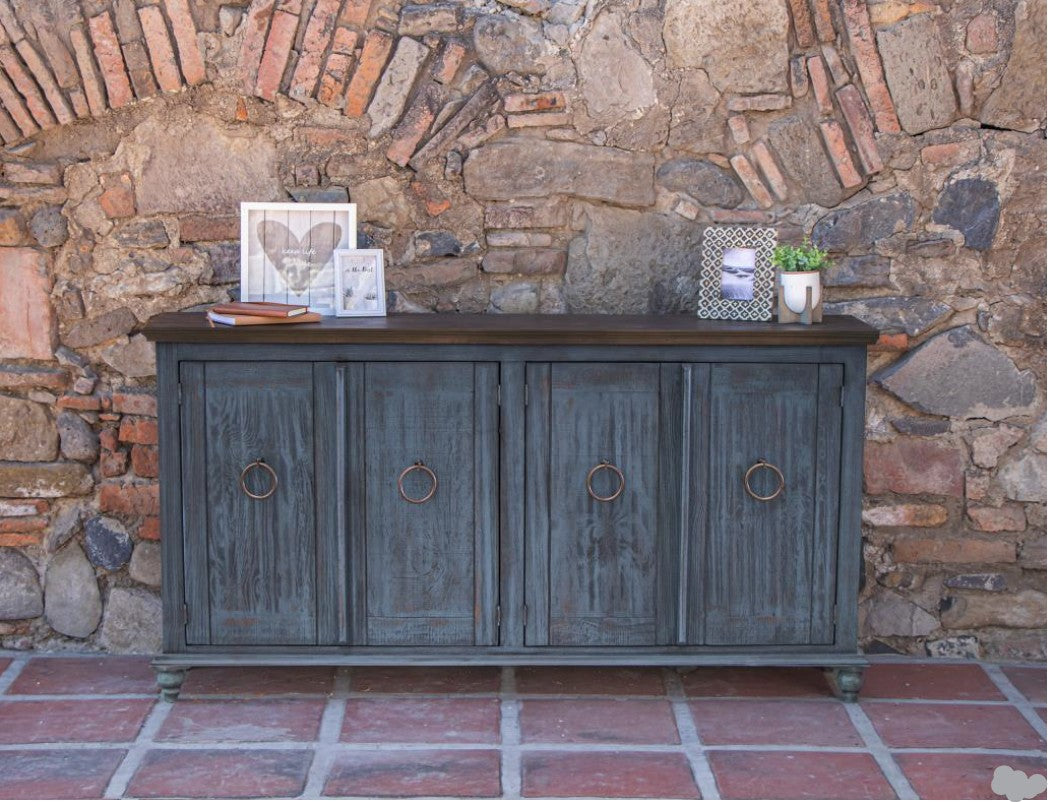 Blue wooden sideboard against a stone wall