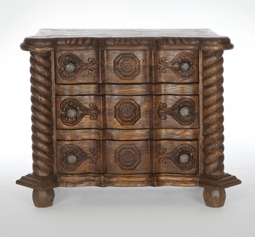 Wooden chest with intricate carvings on a white background