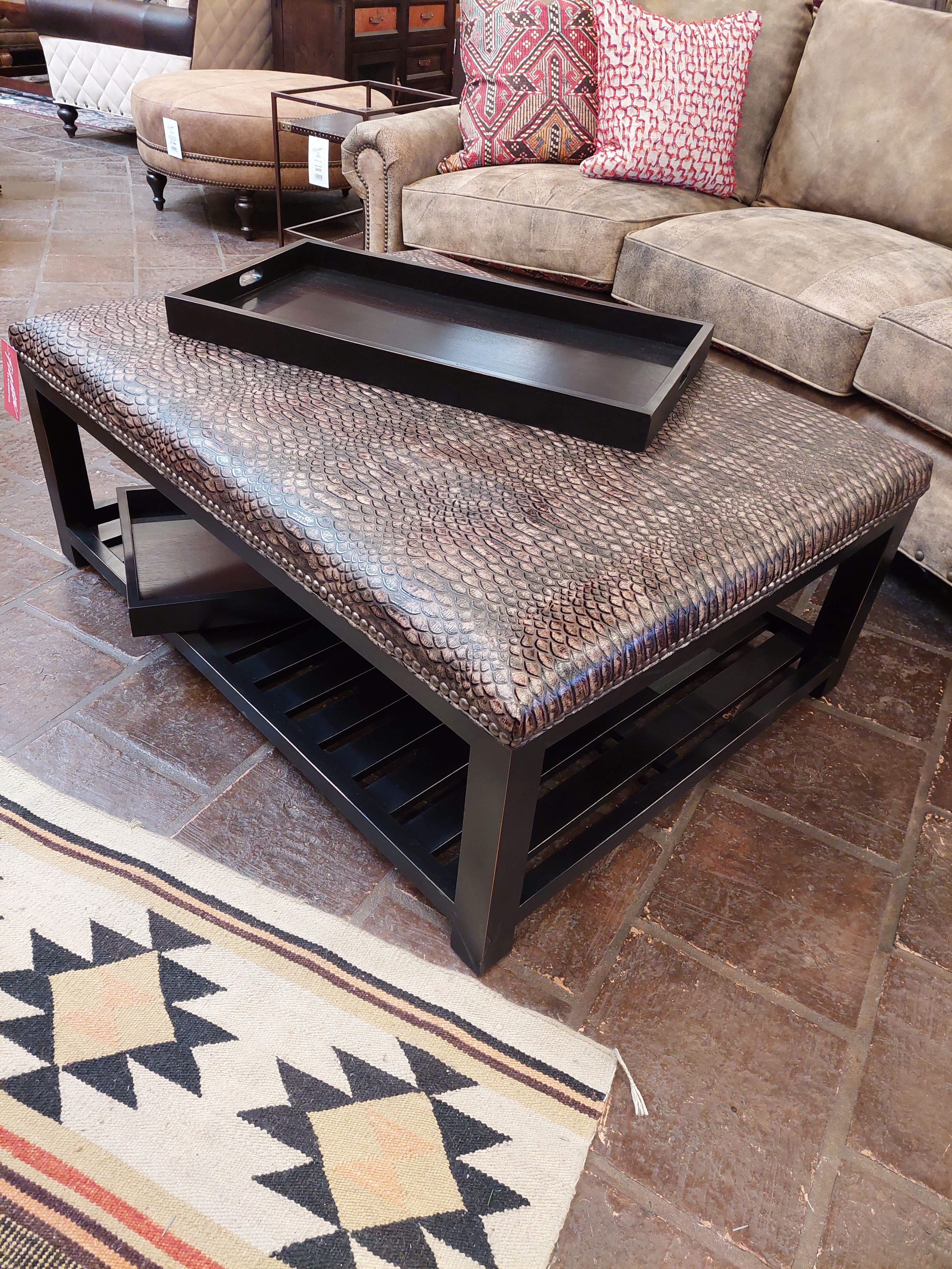 Coffee table with decorative tray in a living room setting
