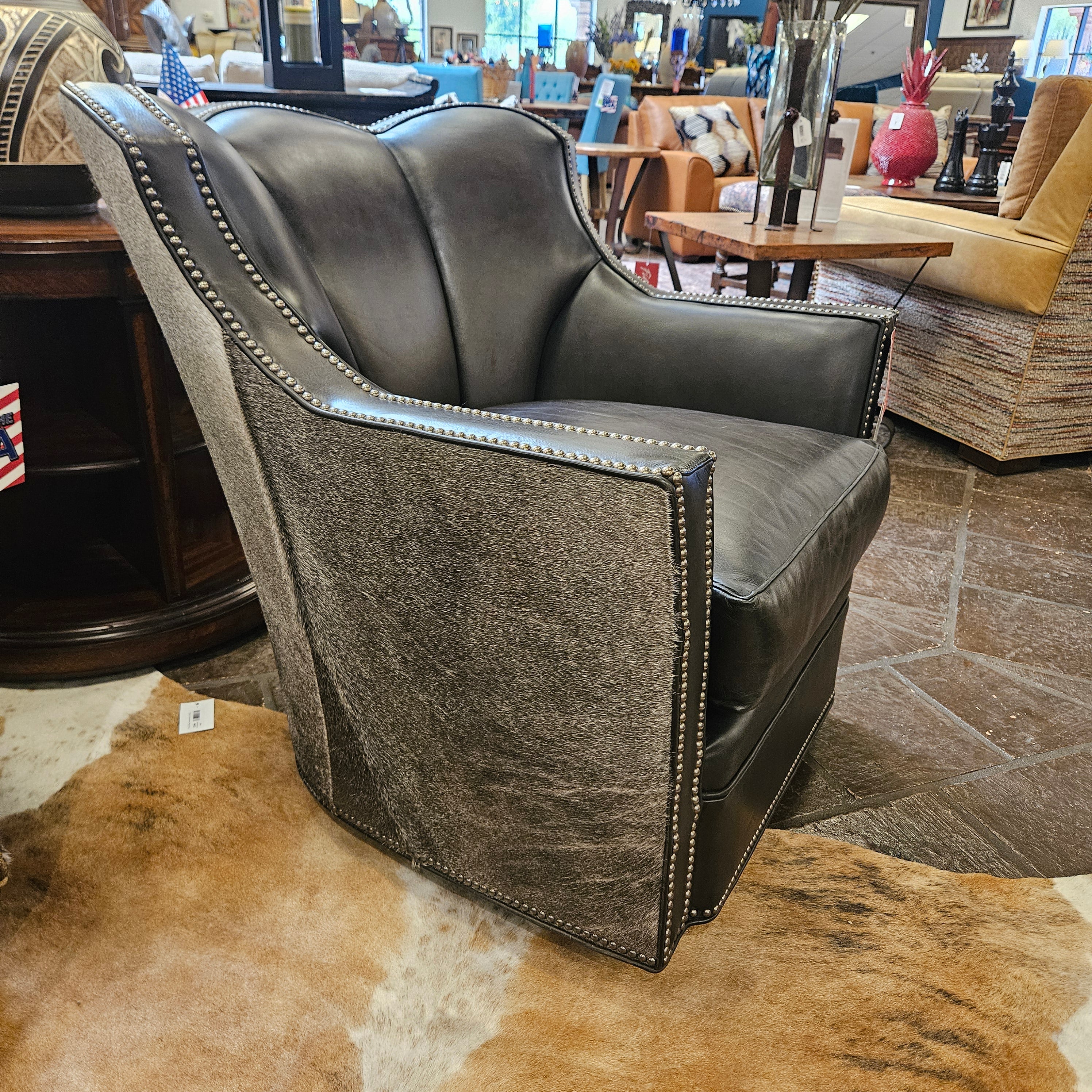 Gray leather chair with nailhead trim in a store setting