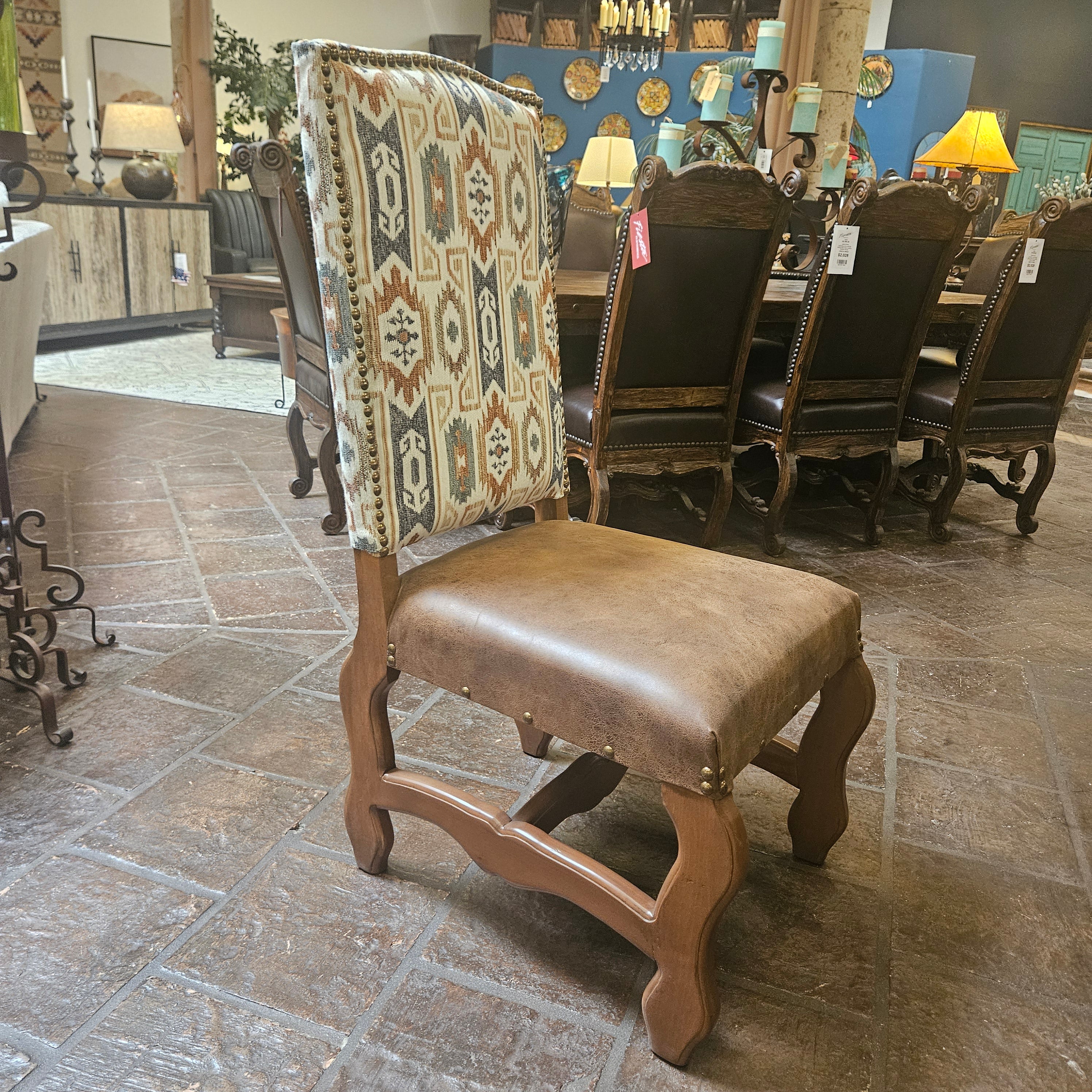 Wooden chair with patterned cushion on a stone floor