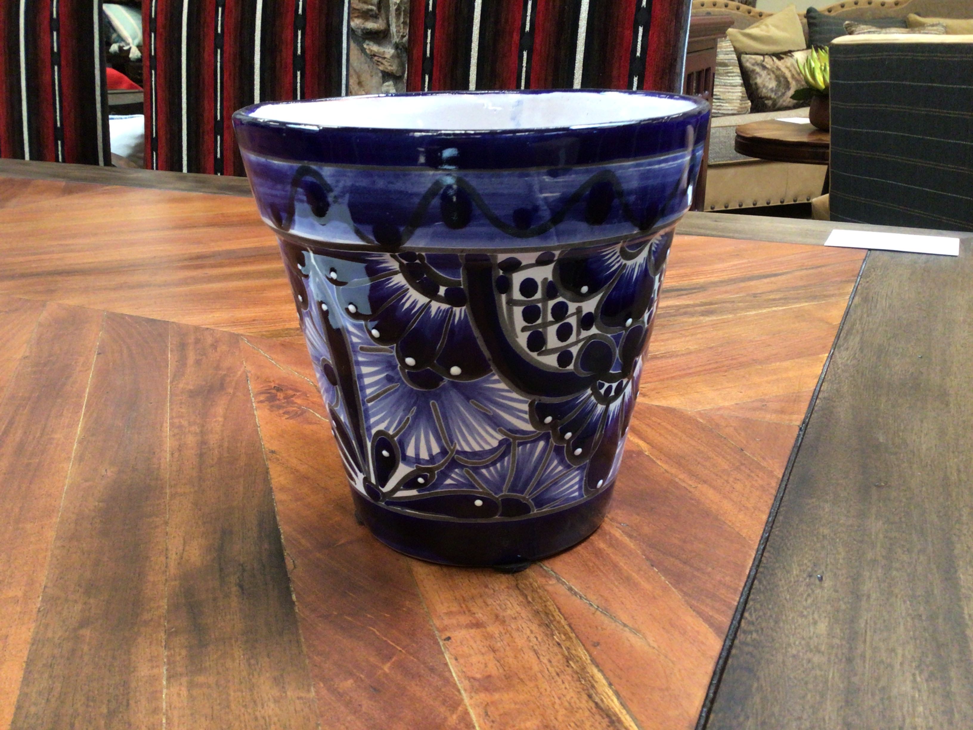 Blue ceramic pot with intricate patterns on a wooden table