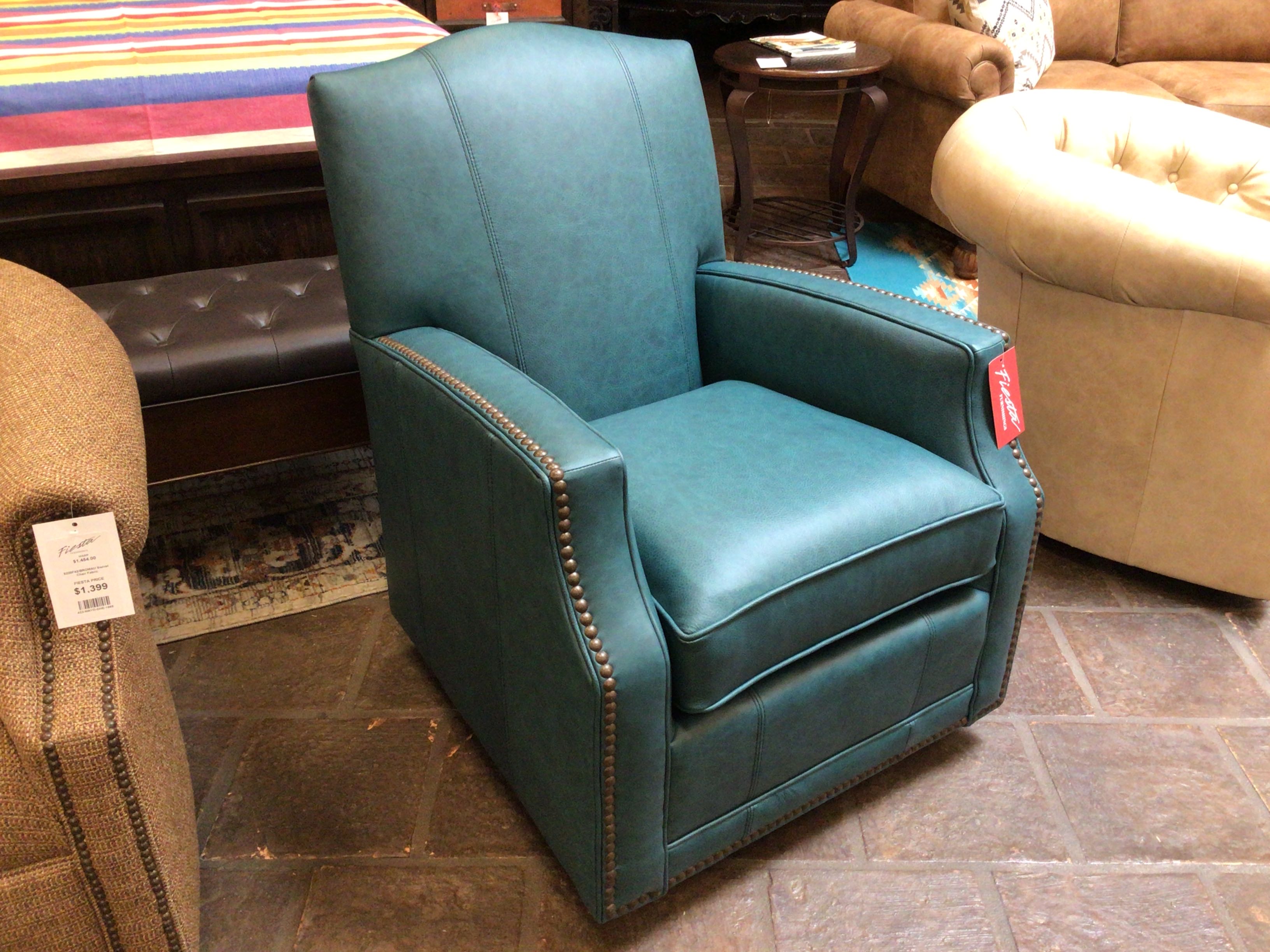 Teal armchair with a price tag in a furniture store setting