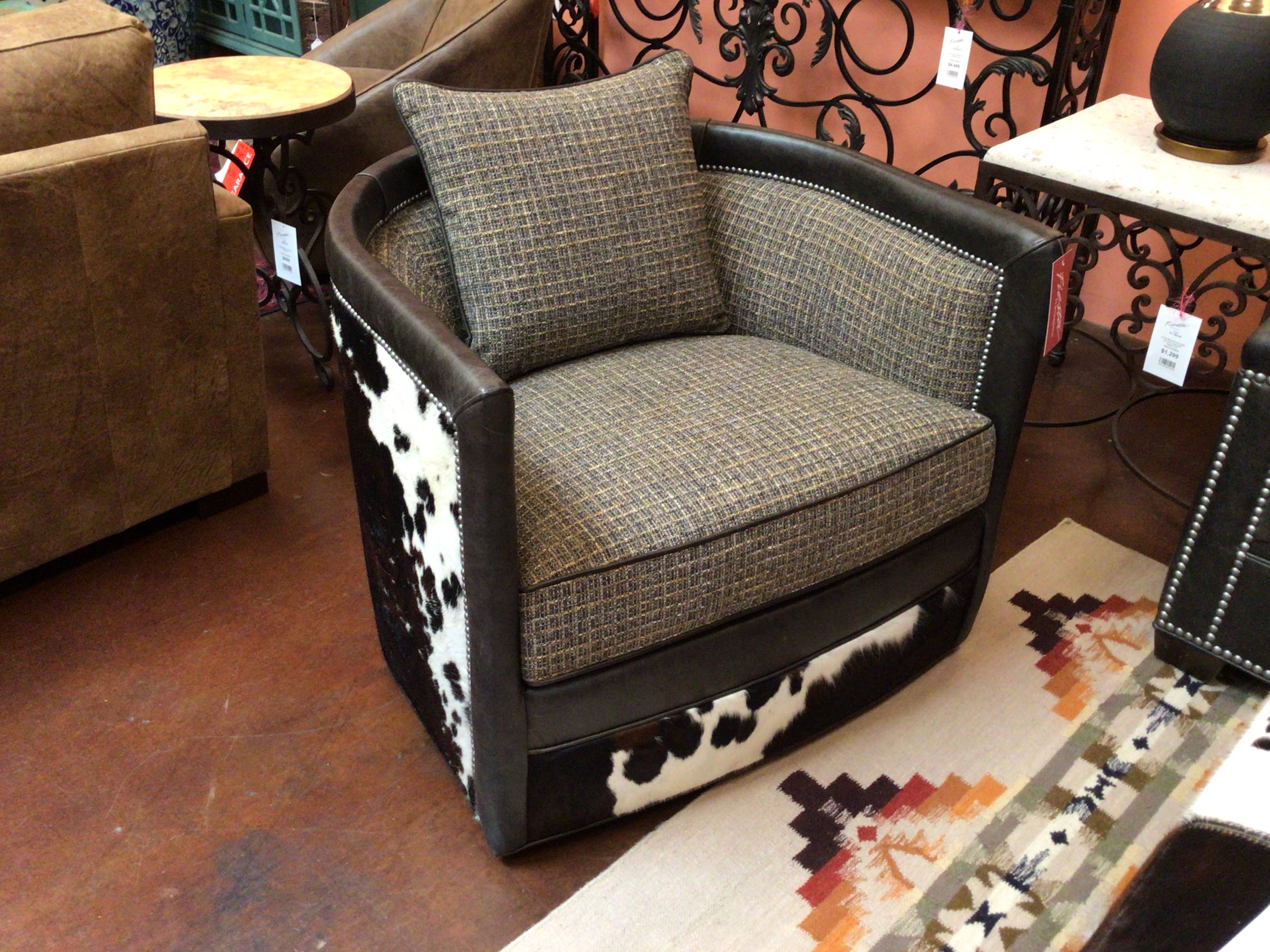 Chair with cowhide pattern and textured cushion in a showroom setting