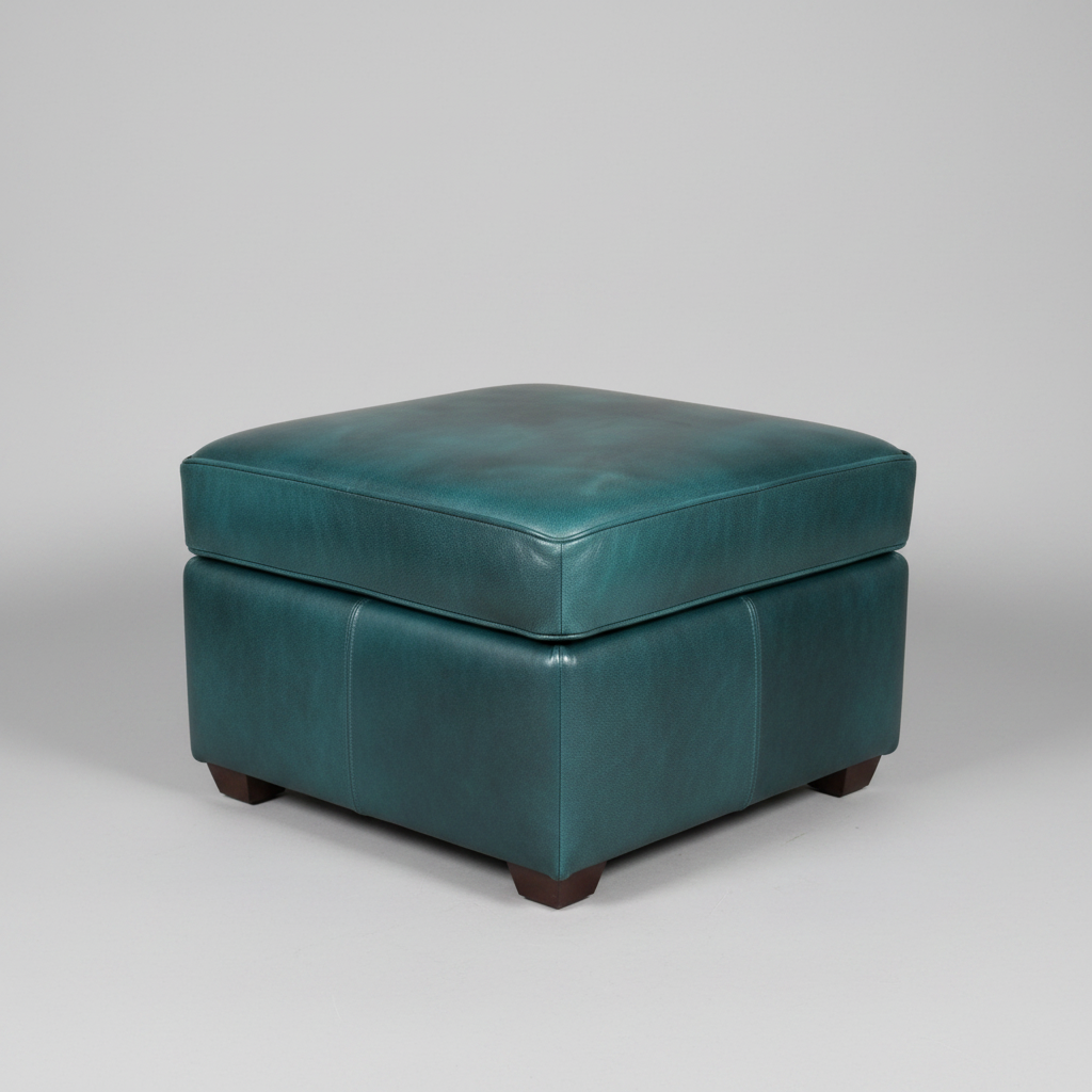 Teal leather ottoman on a gray background