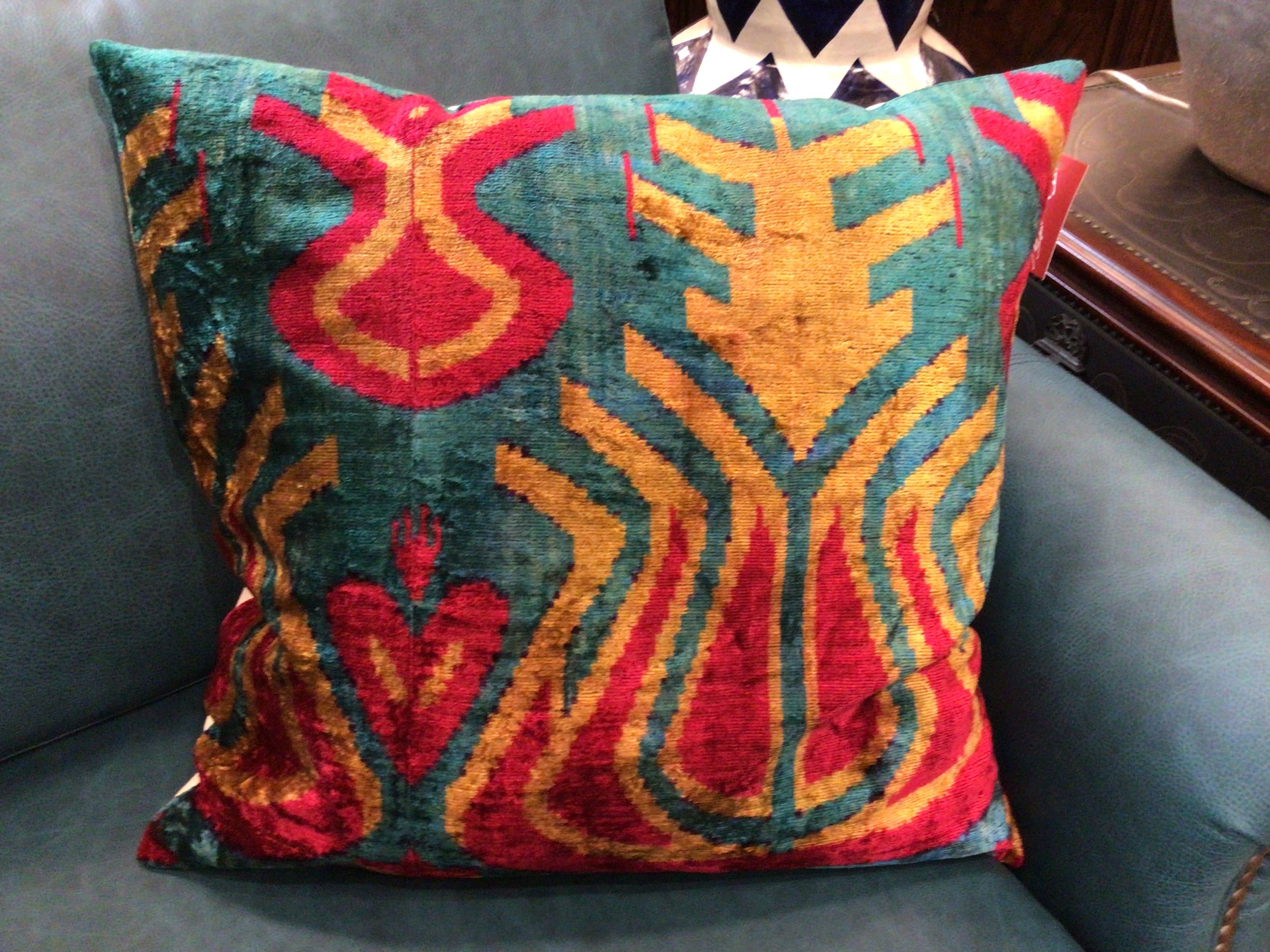 Decorative pillow with colorful pattern on a gray couch