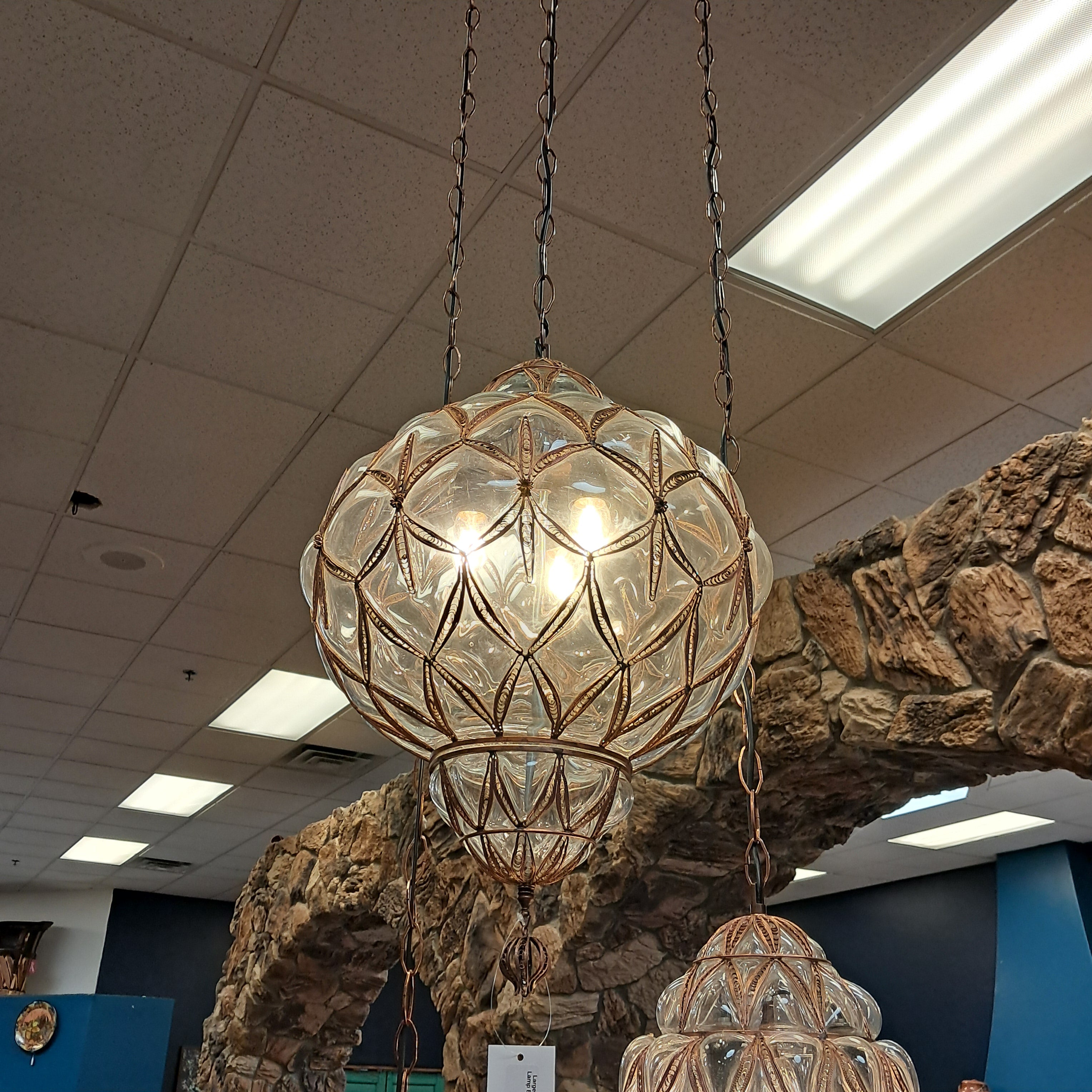 Decorative chandelier hanging from a stone wall