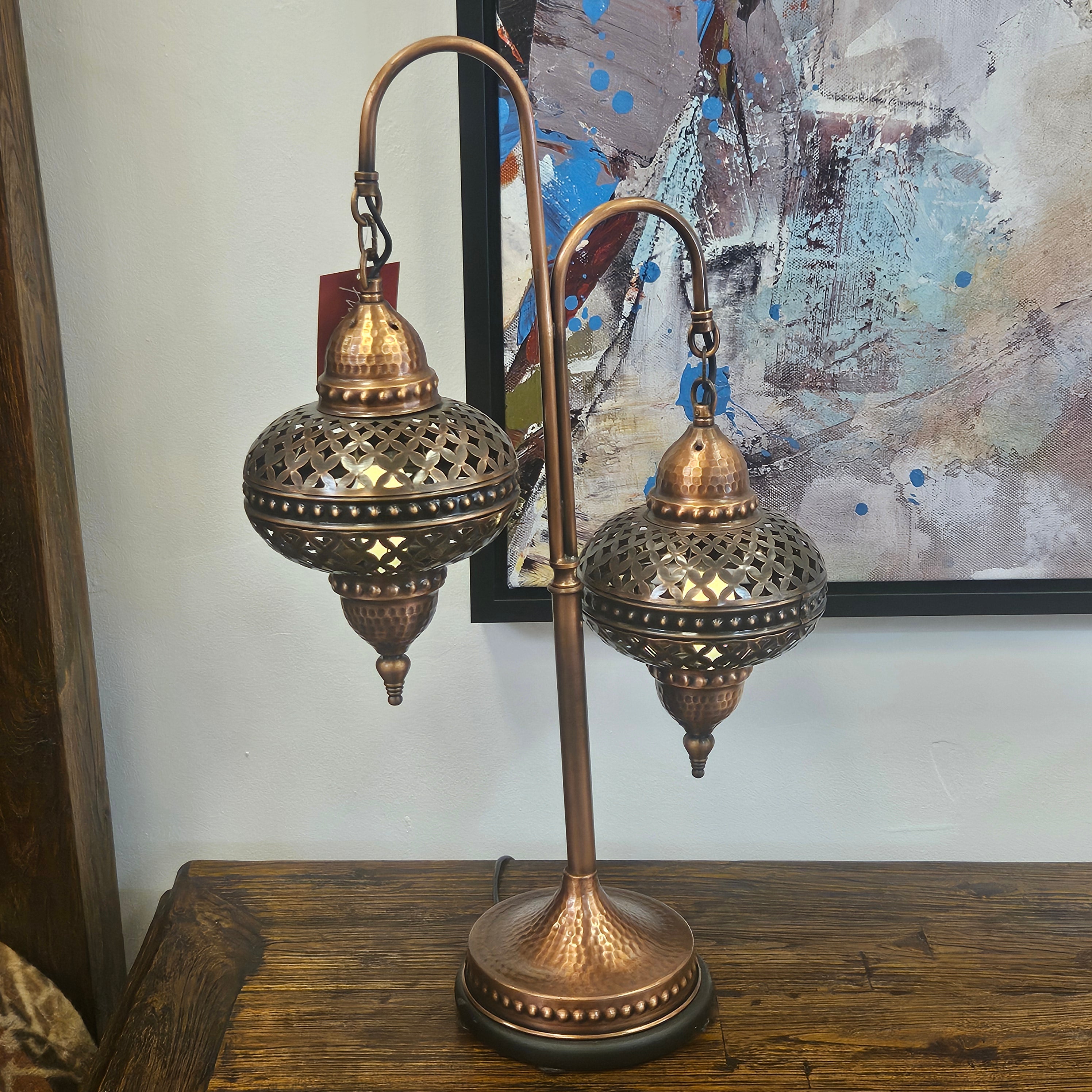 Decorative lamp with intricate design on a wooden surface