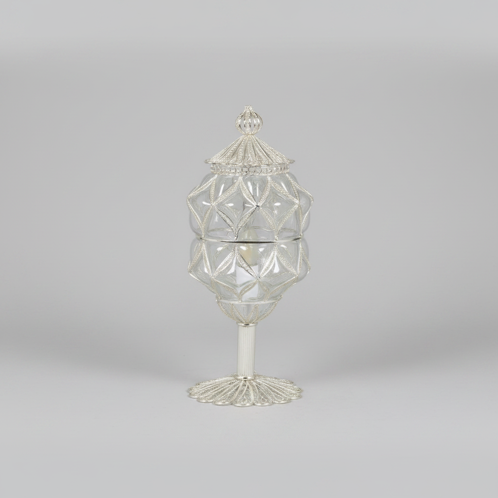 Decorative glass container with geometric design on a gray background