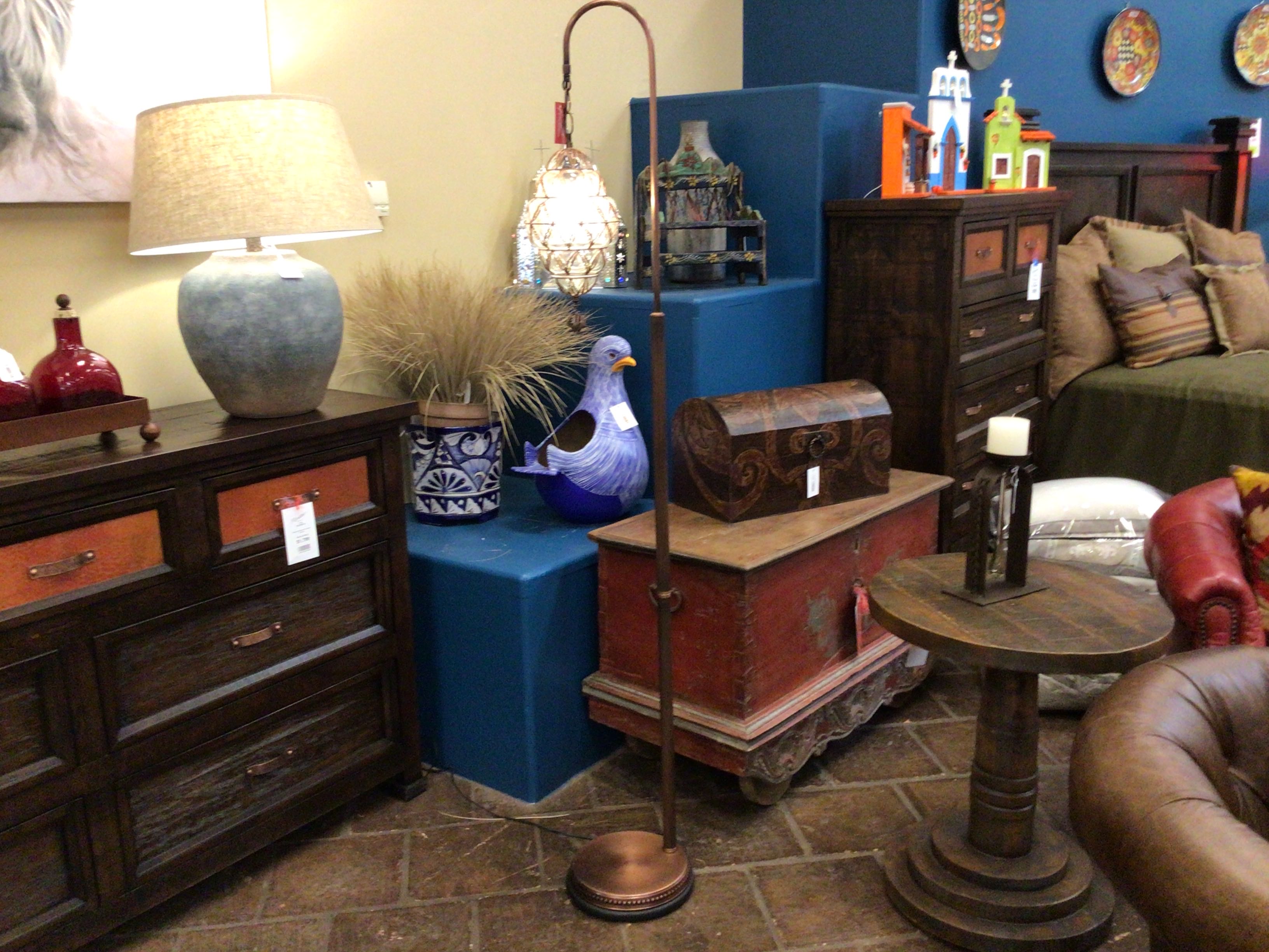 Living room with wooden furniture, decorative items, and a lamp.