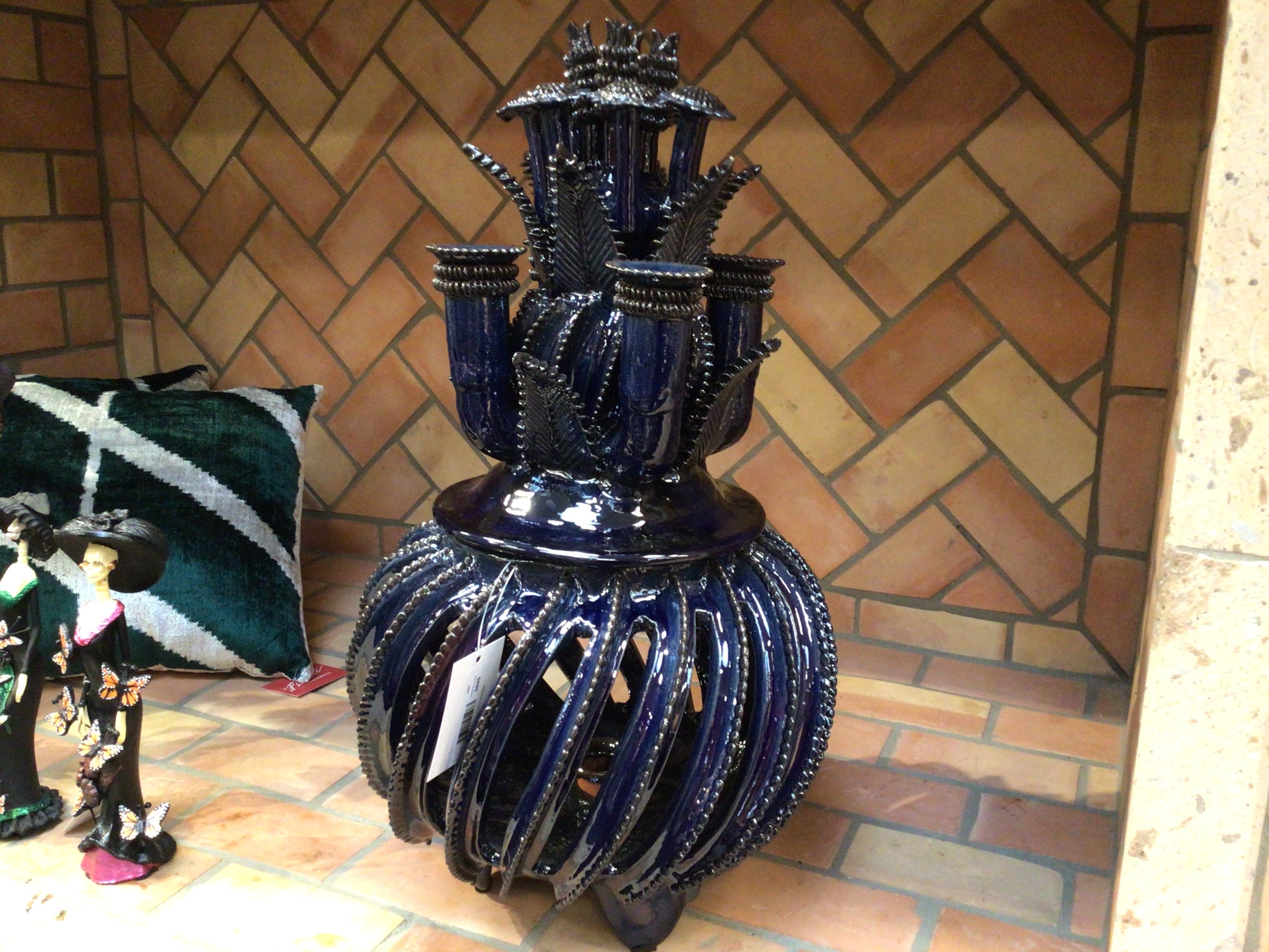 Decorative blue vase with intricate design on a tiled floor.