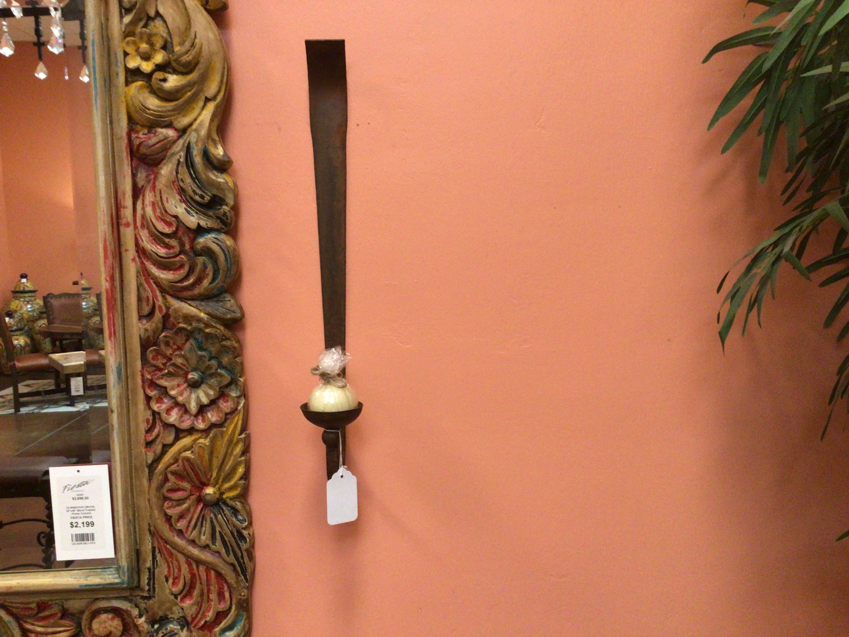 Decorative wall hook with floral design on a peach-colored wall