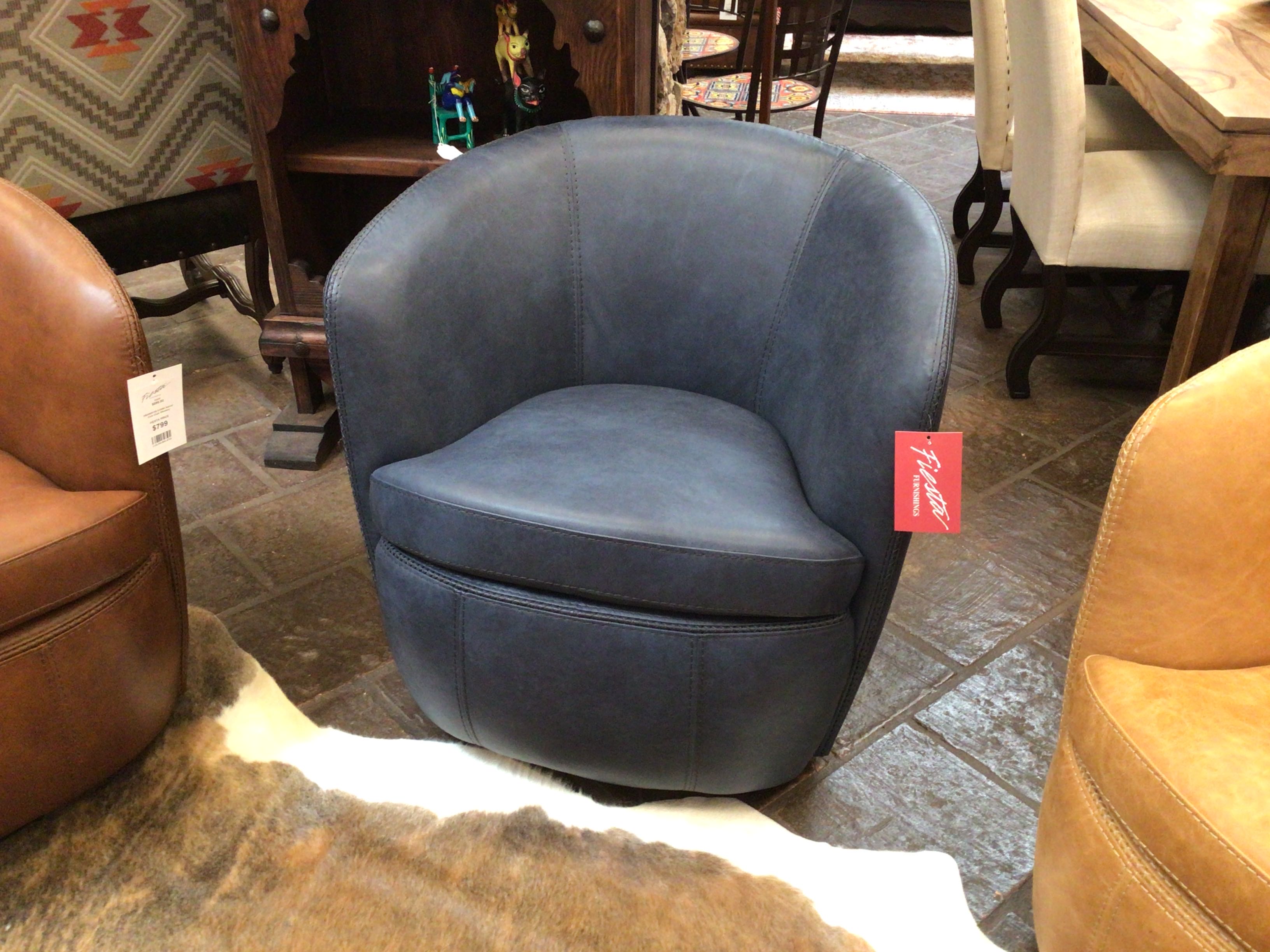 Blue swivel chair in a showroom with other chairs and furniture.