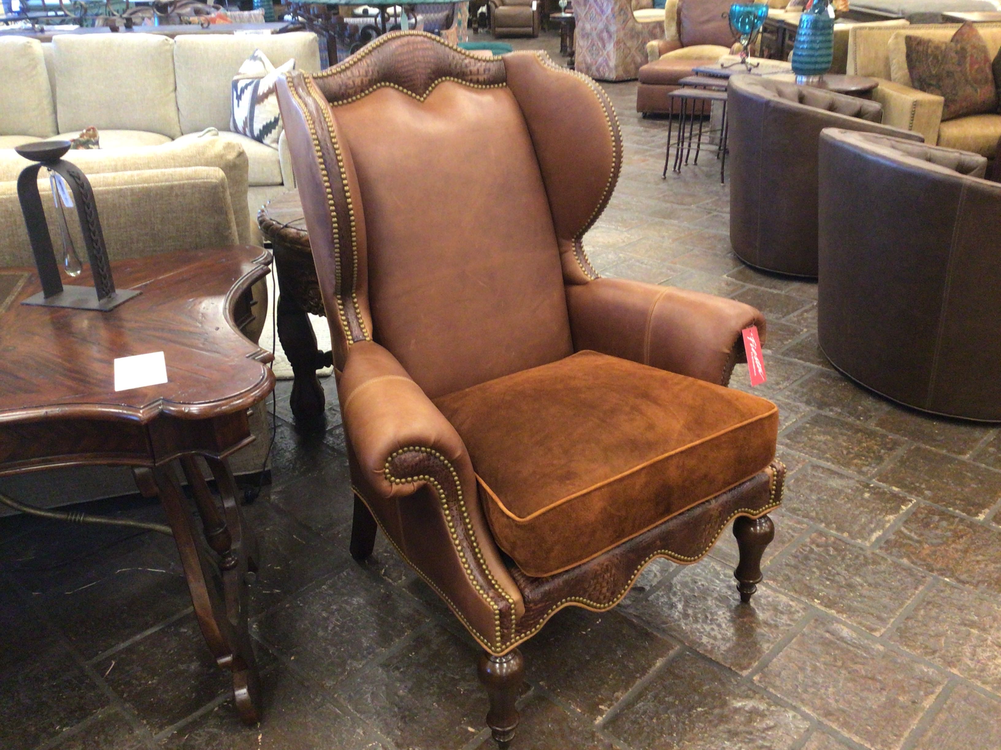 Brown leather wingback chair in a furniture store setting