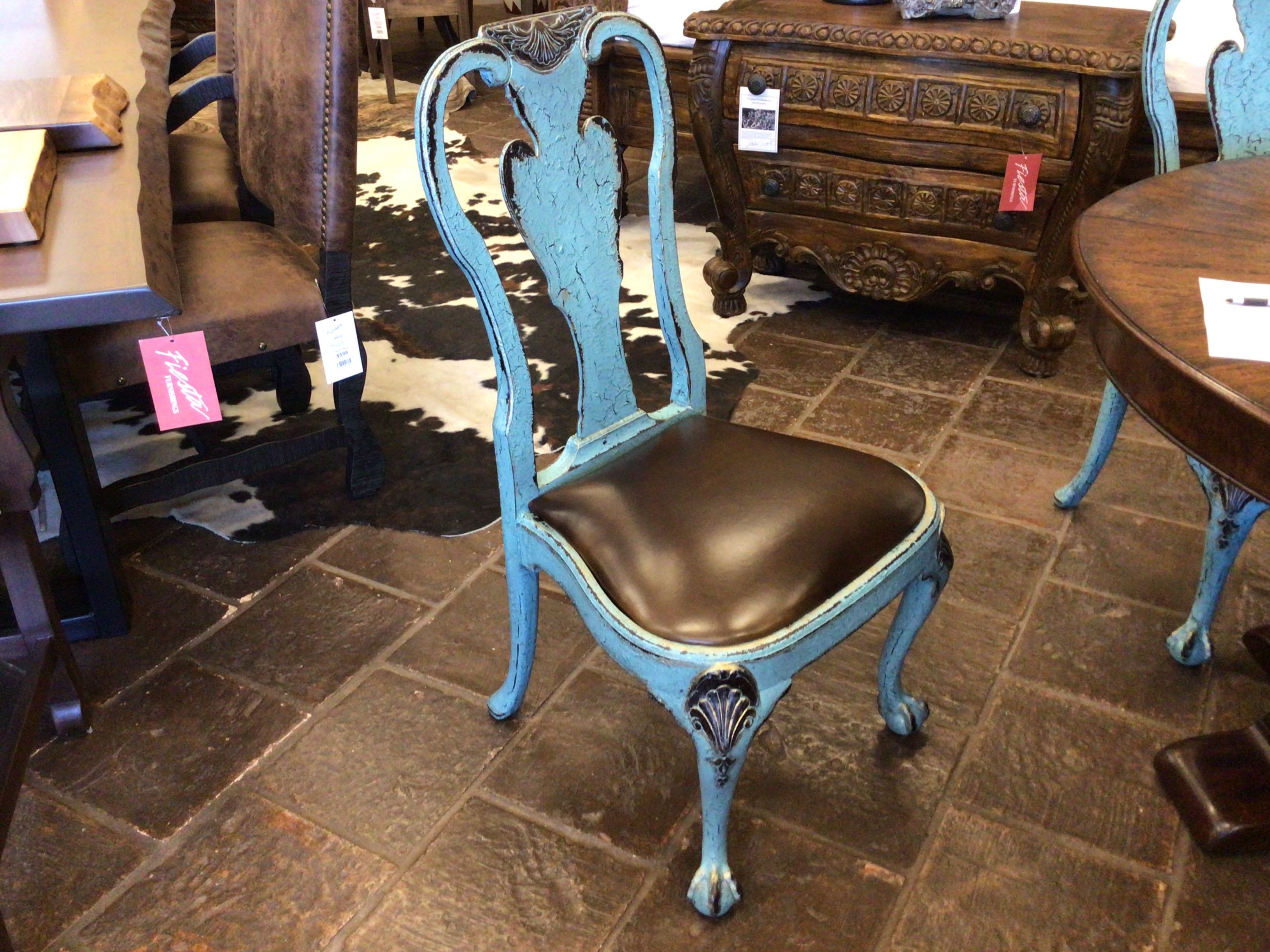 Blue chair with black seat in a furniture store setting