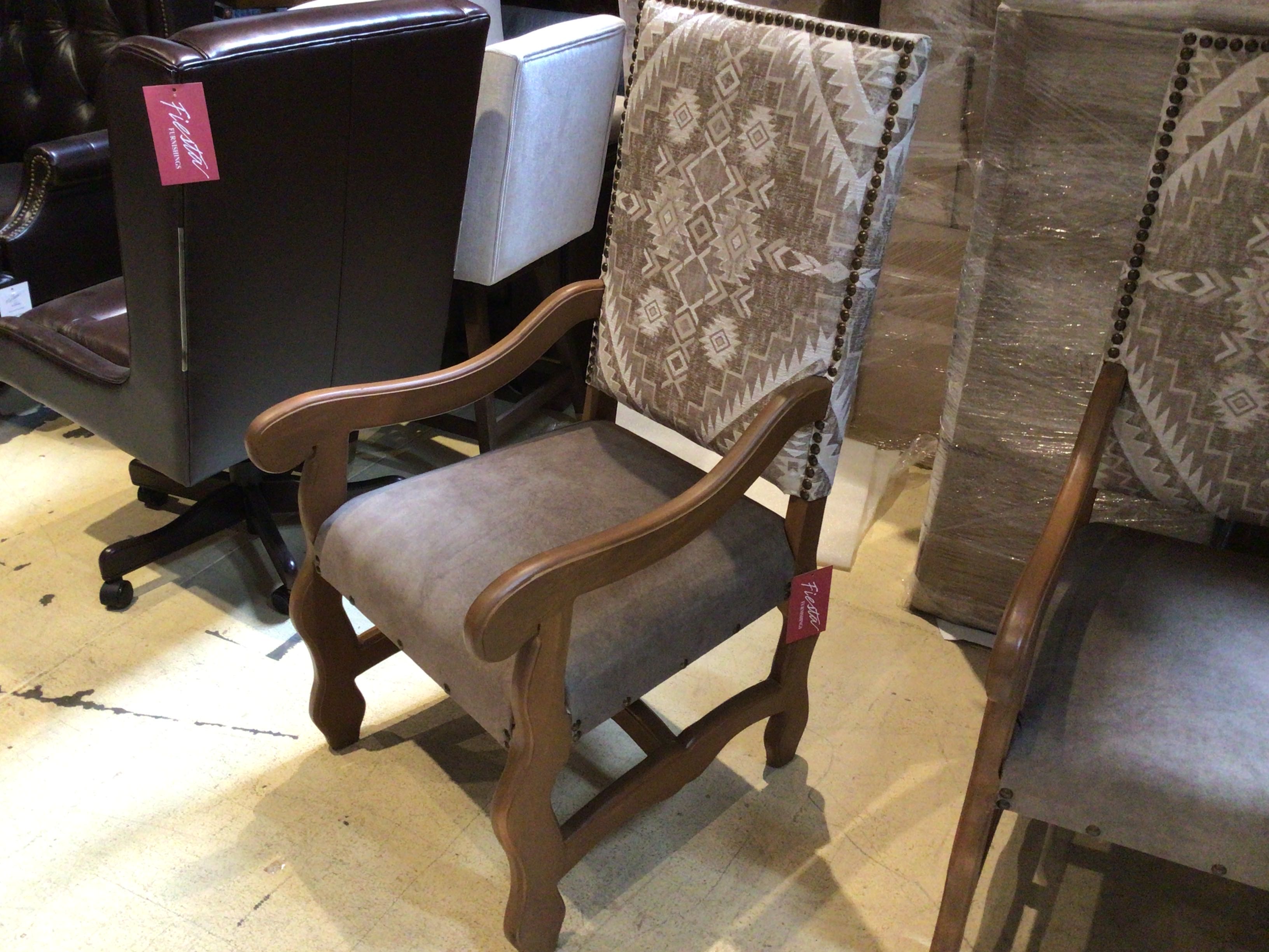 Wooden chair with patterned fabric backrest and seat in a showroom setting