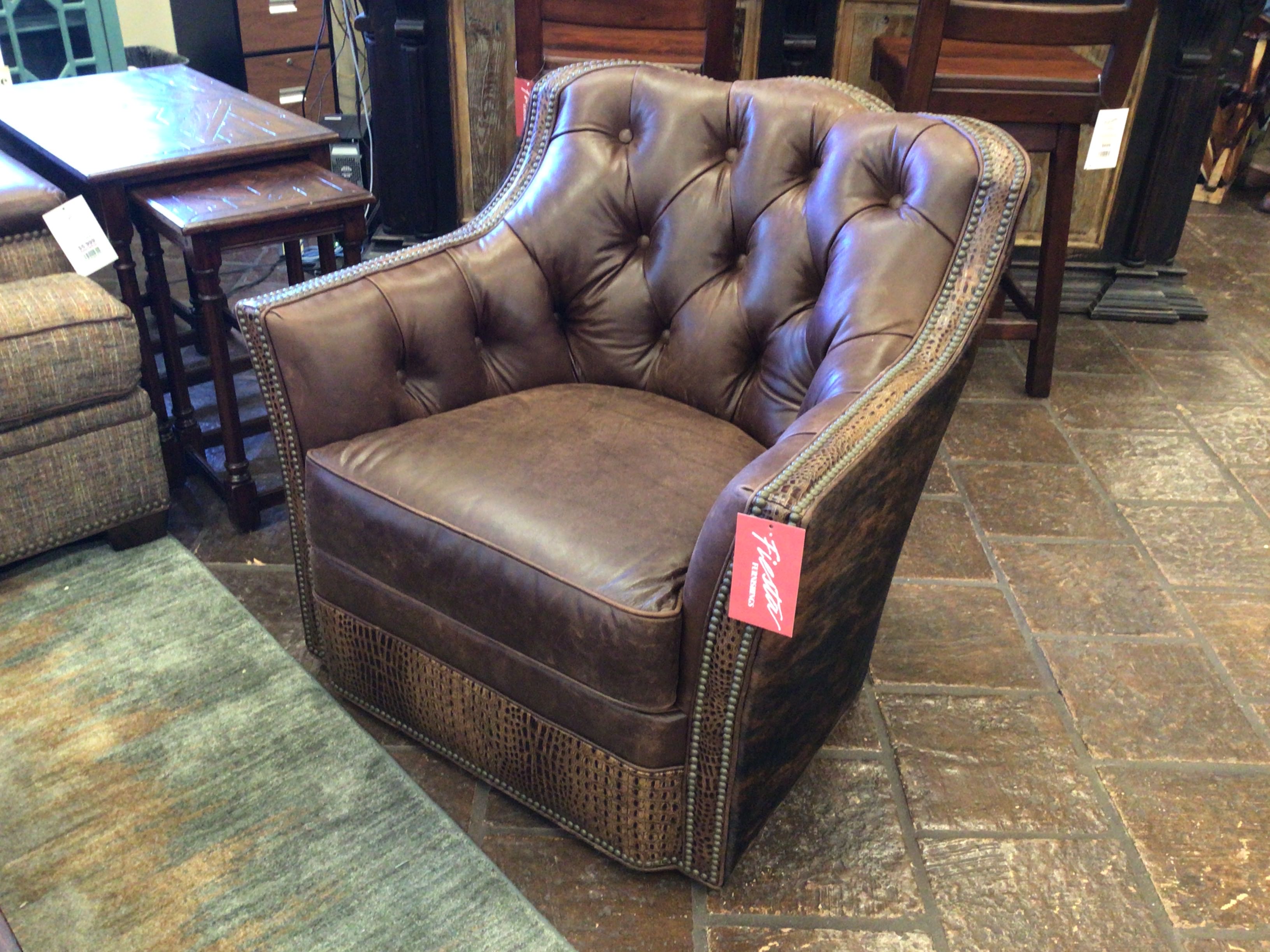 Brown leather armchair with a price tag in a furniture store setting