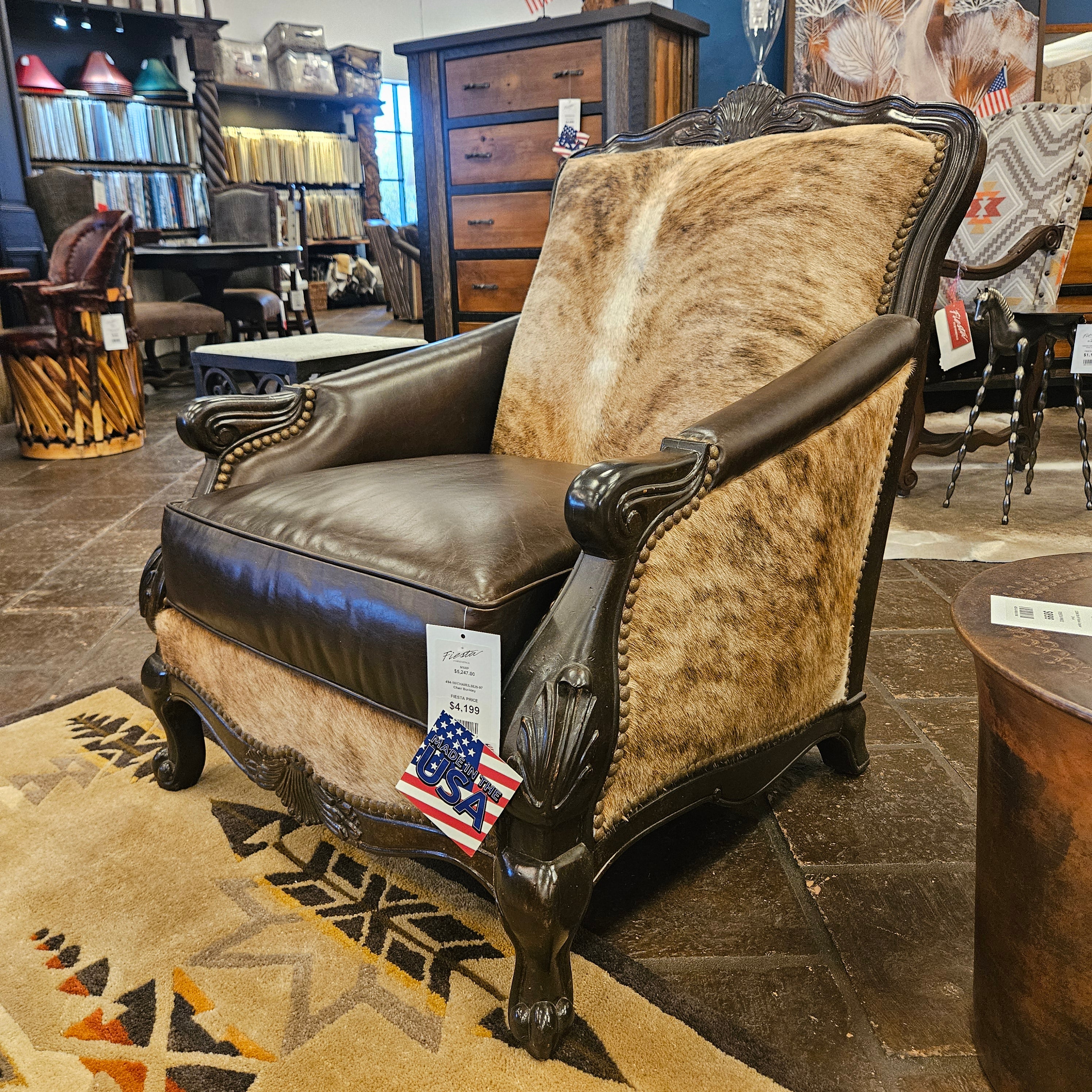 Decorative chair with cowhide pattern and leather accents in a store setting.