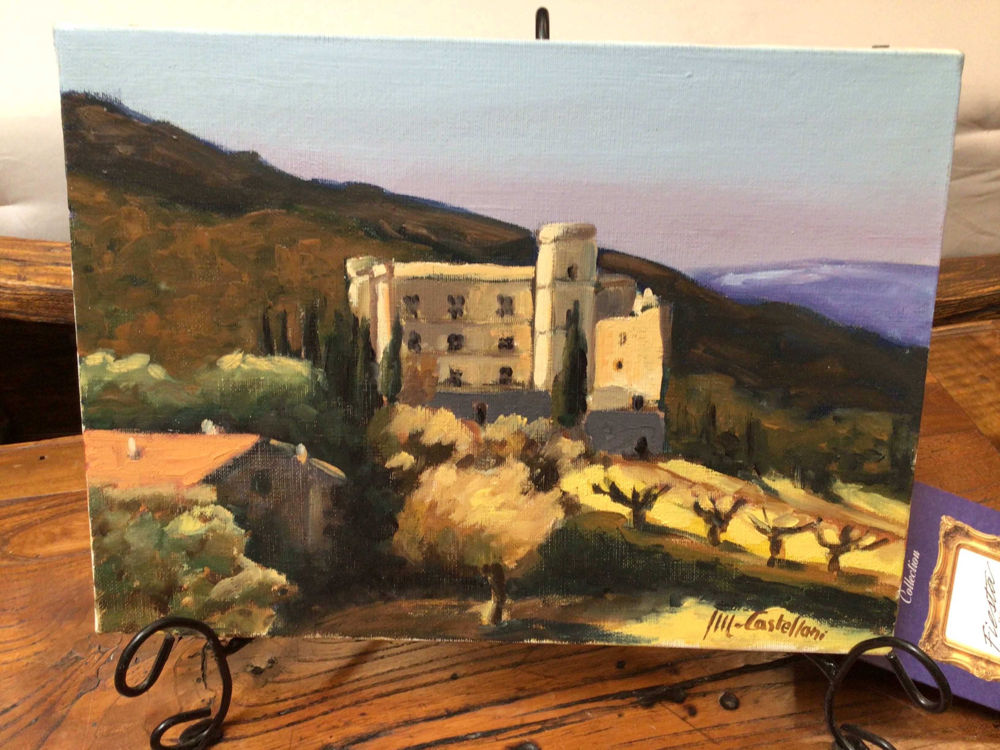 Painting of a castle on a wooden surface