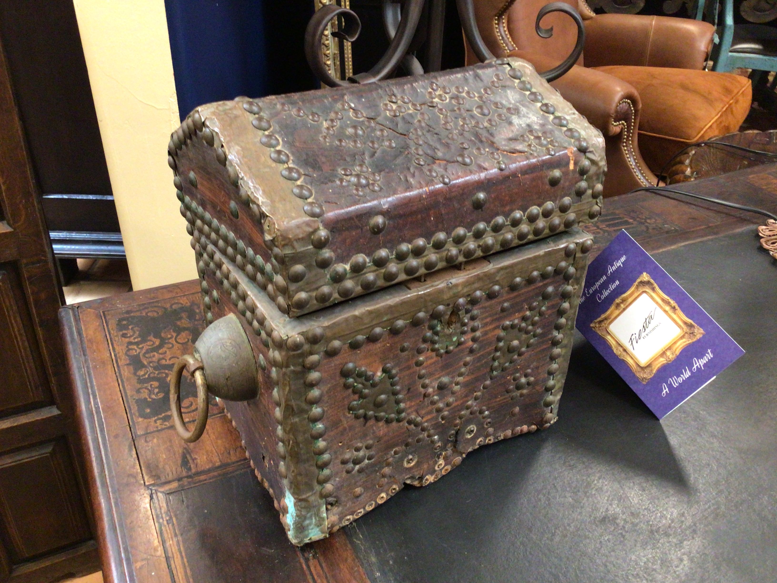 Vintage wooden chest with metal accents on a table with a card in the background