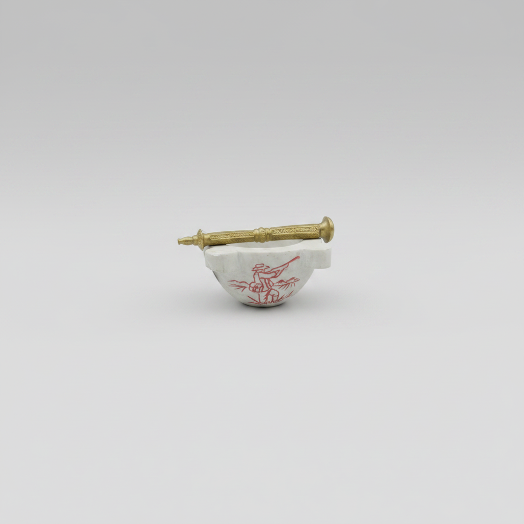 Small white ceramic bowl with red design and gold handle on a light gray background