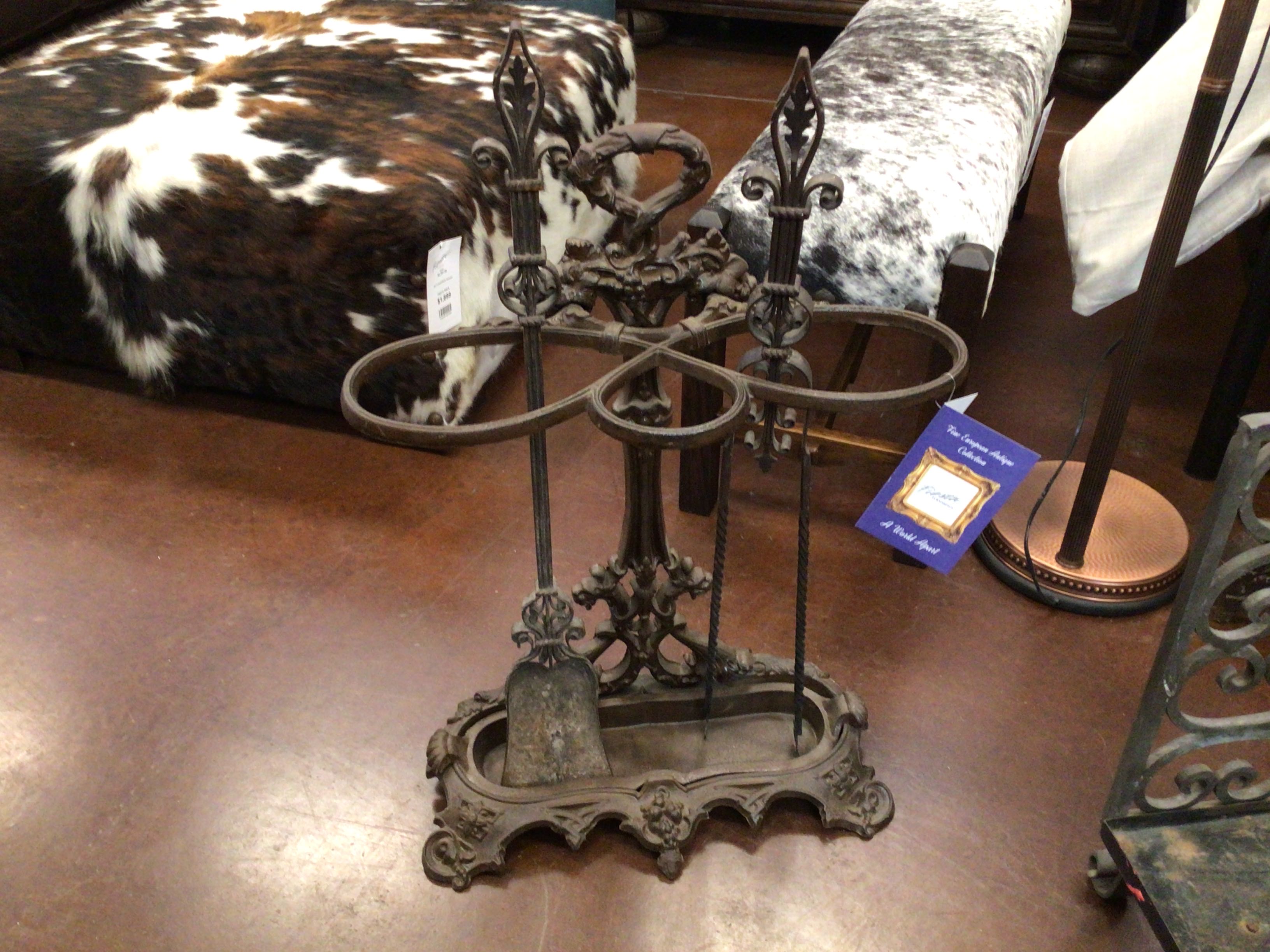 Decorative metal stand on a wooden floor with a cowhide rug in the background