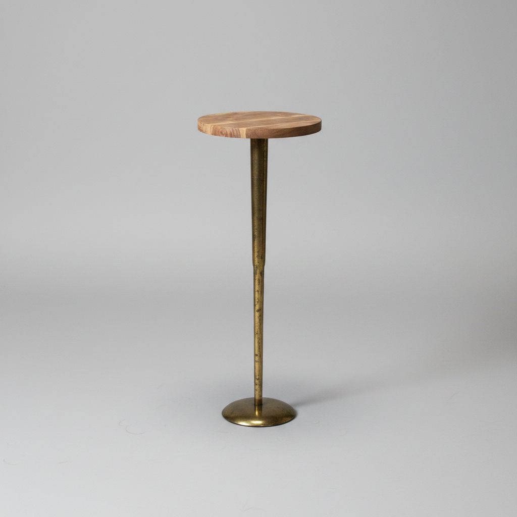 Small round wooden table with a brass pedestal base on a gray background