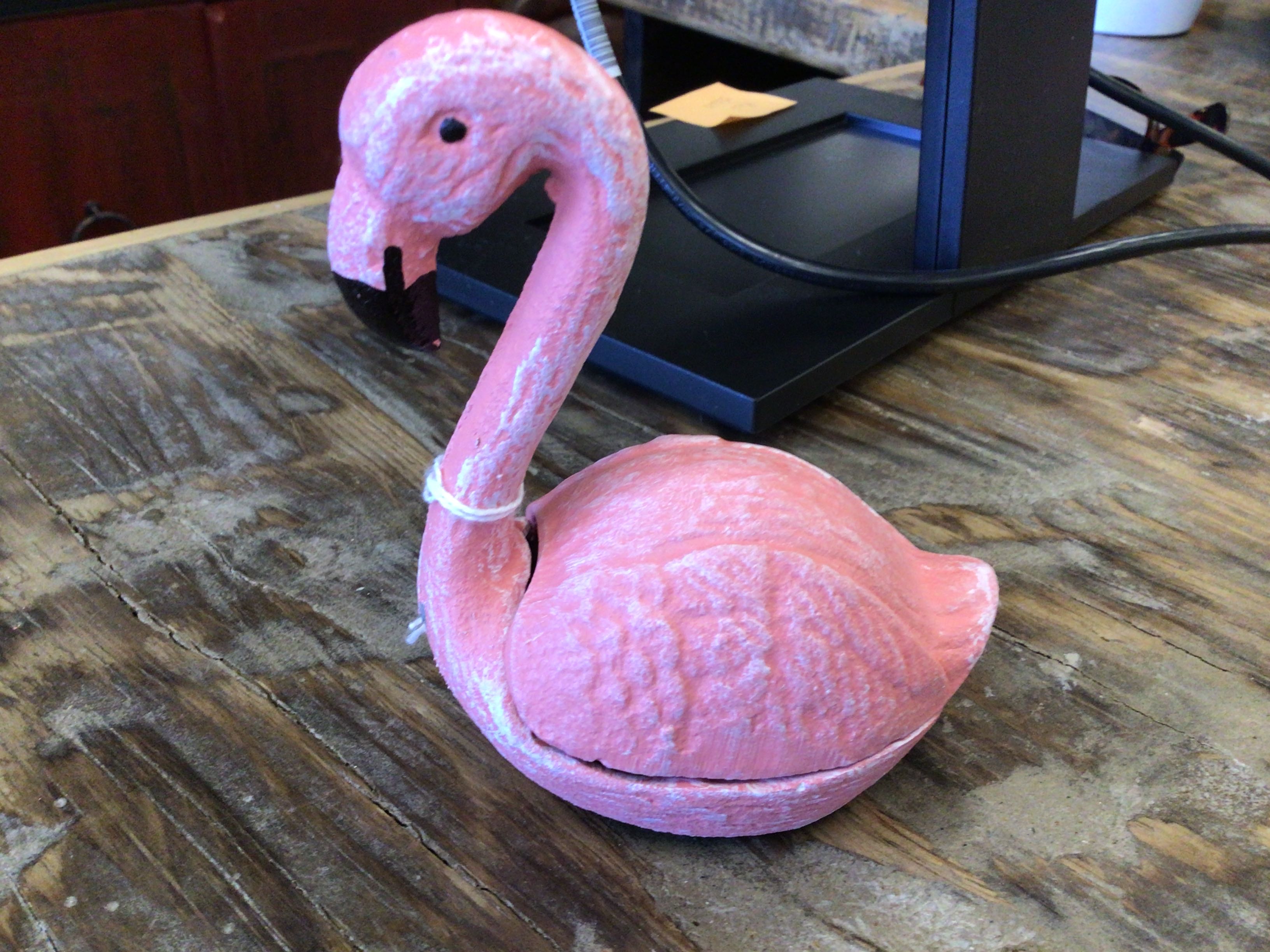 Pink flamingo clay key jar on a wooden desk