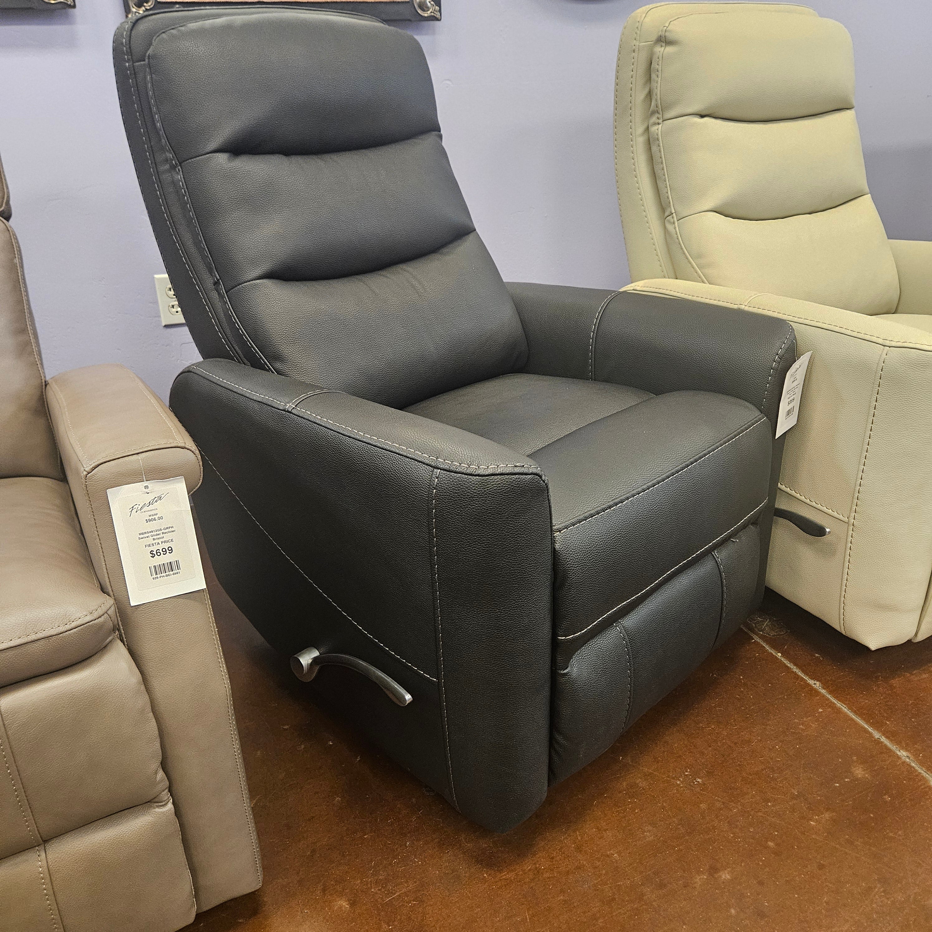 Charcoal leather recliner chair on display with price tag.