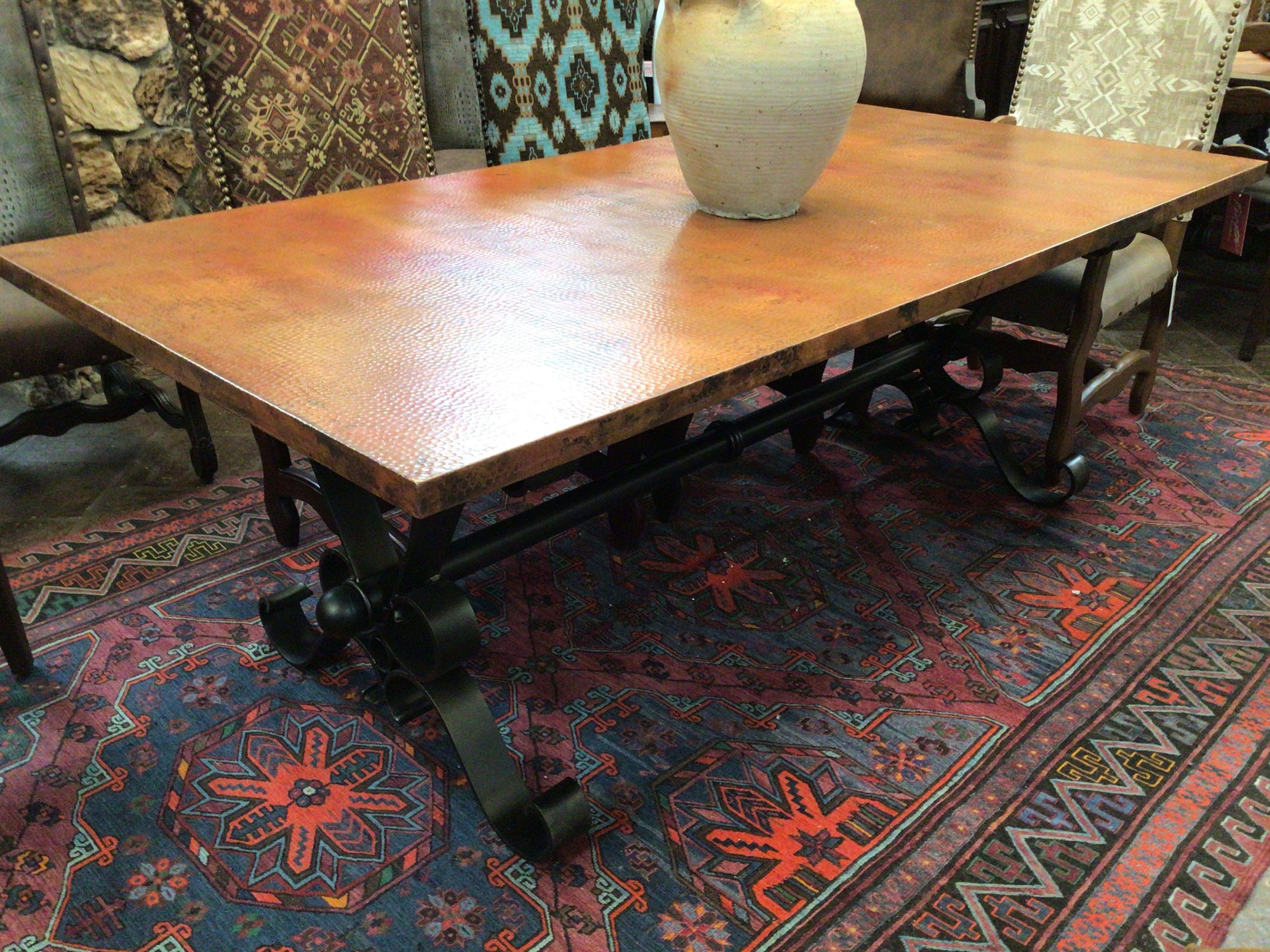 Wooden table with metal legs on a patterned rug
