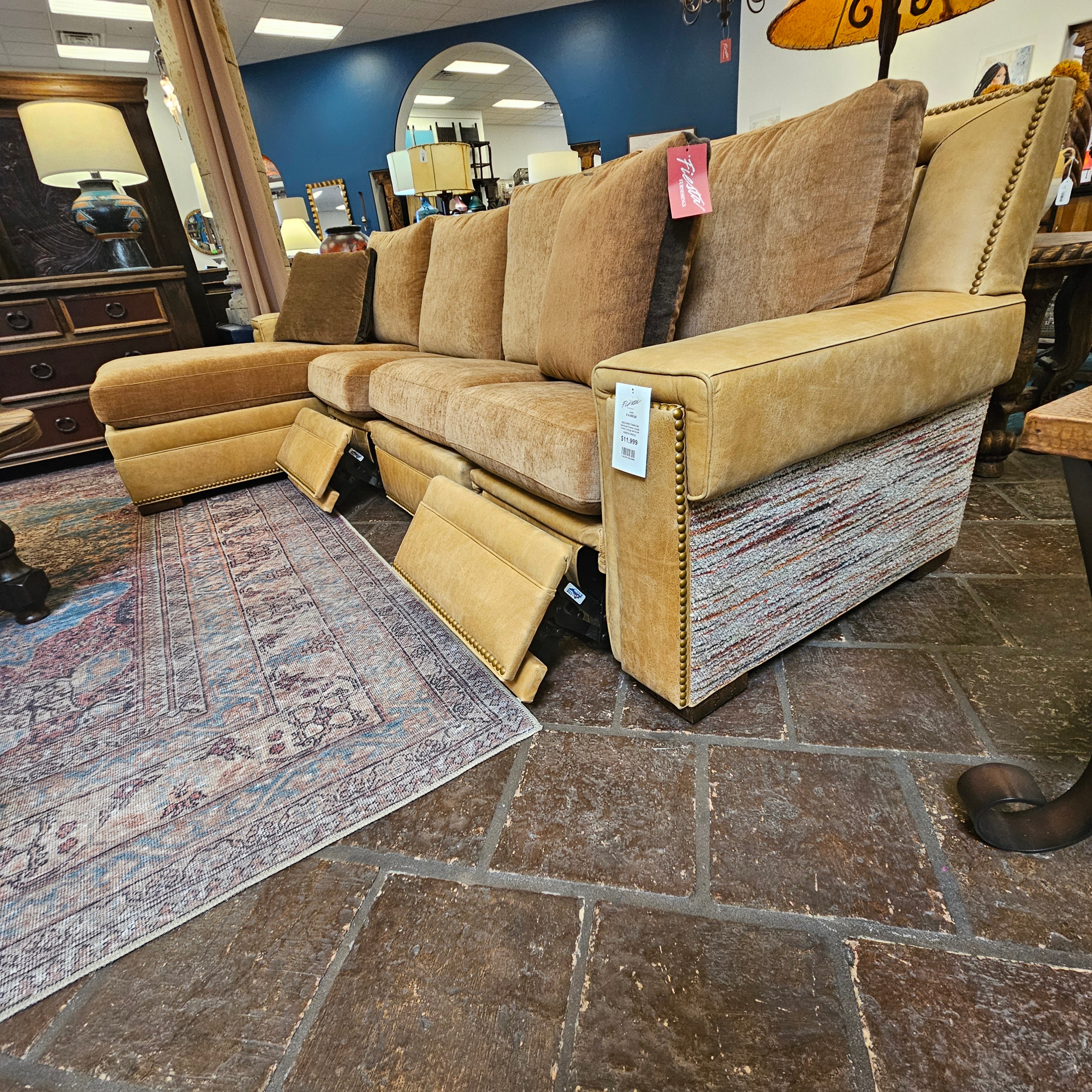 Beige sectional sofa with tags in a showroom setting