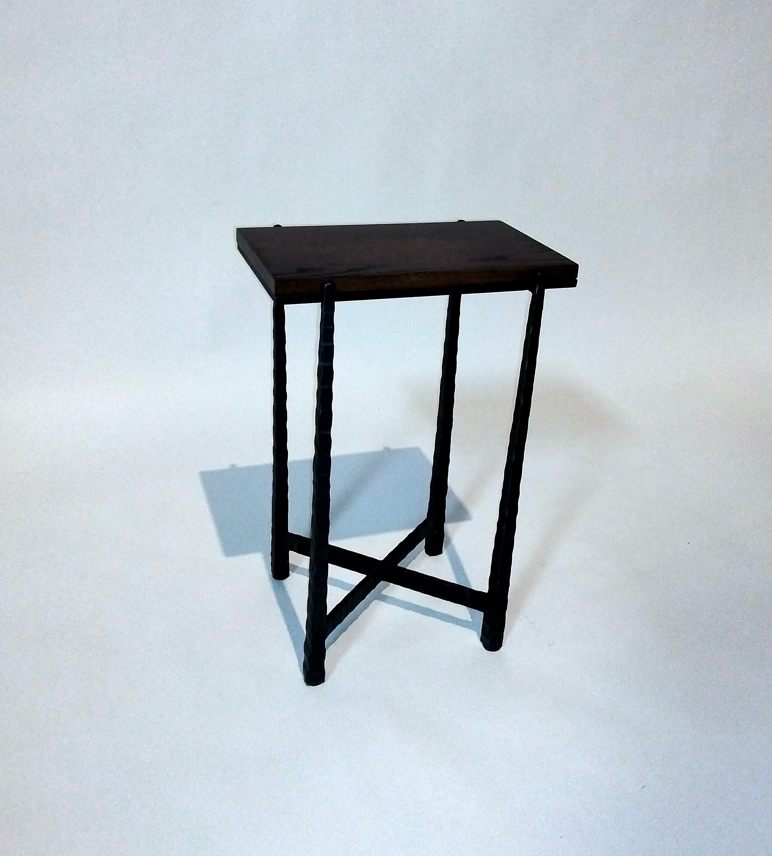 Small black metal table on a white background