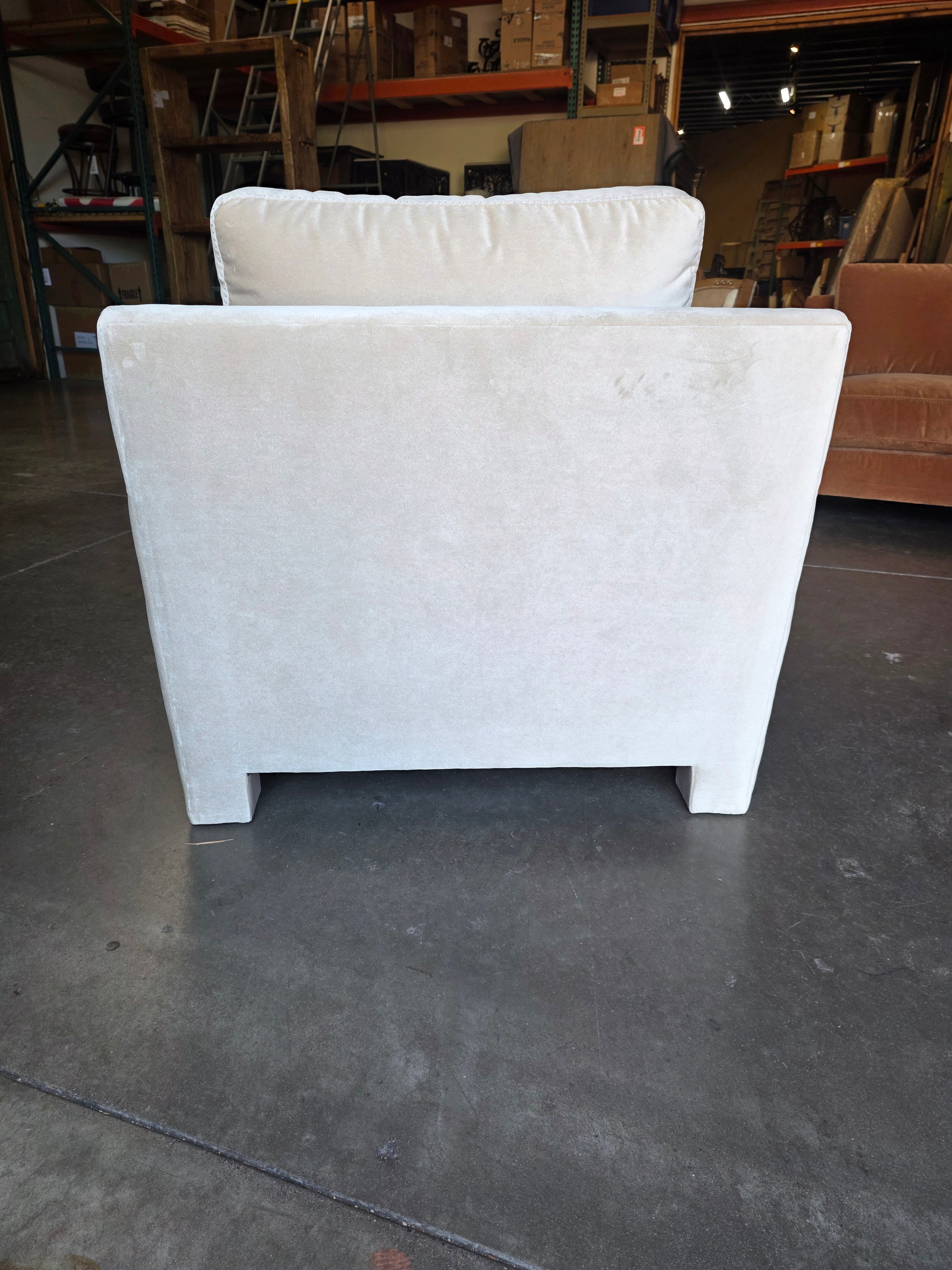 White mattress on a black platform with a warehouse background
